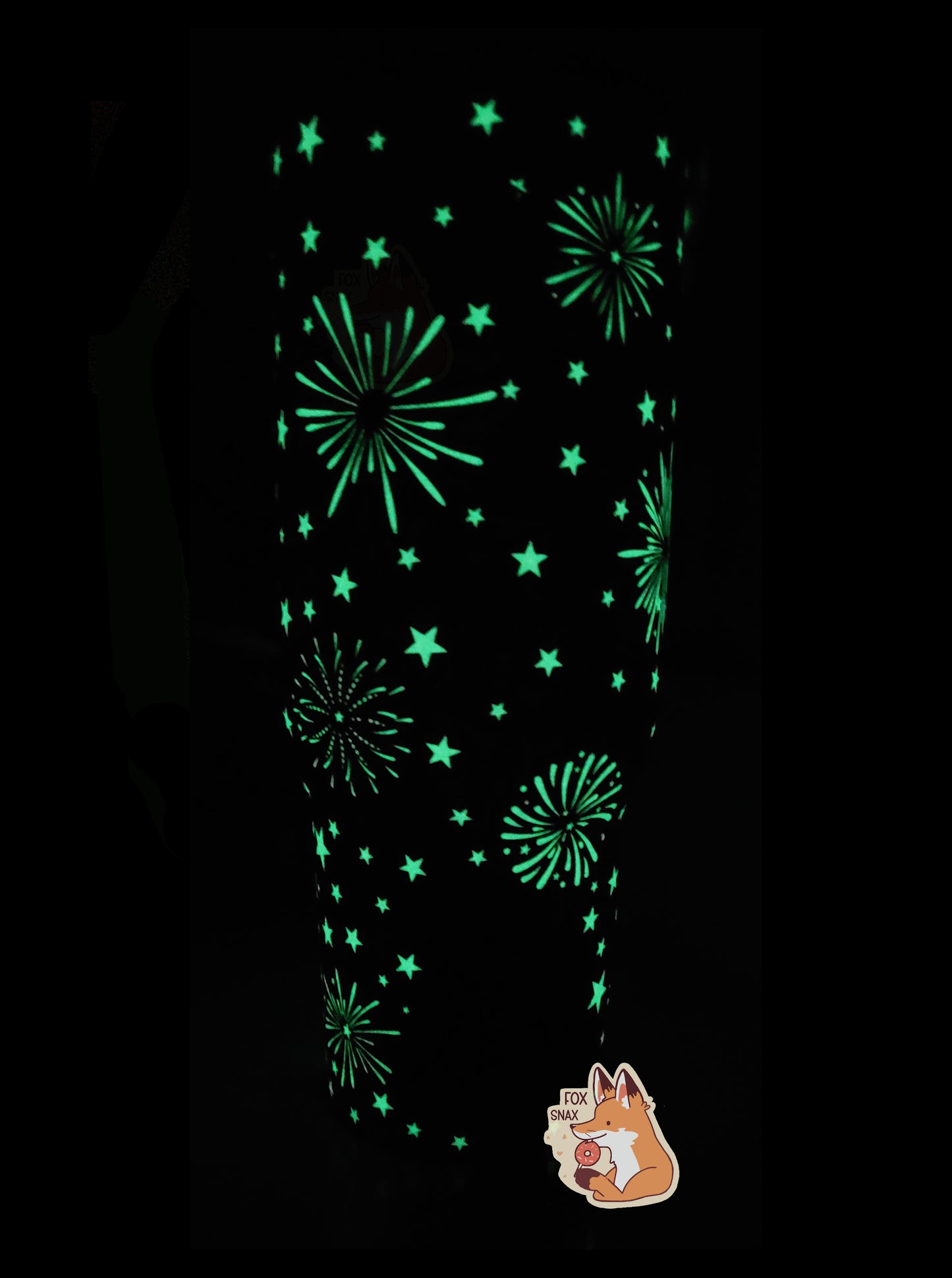 A picture of the back of a tall, sorta skinny tumbler.  The fireworks that are normally in white are in fluorescent bright green, as it is a glow in the dark mug.  The mug's surface shows exploding fireworks of different sizes, framed against five-pointed stars.  The lid and handle cannot be seen very well in the picture because they do not glow in the the dark, nor does the Buc-ee's logo on the bottom.