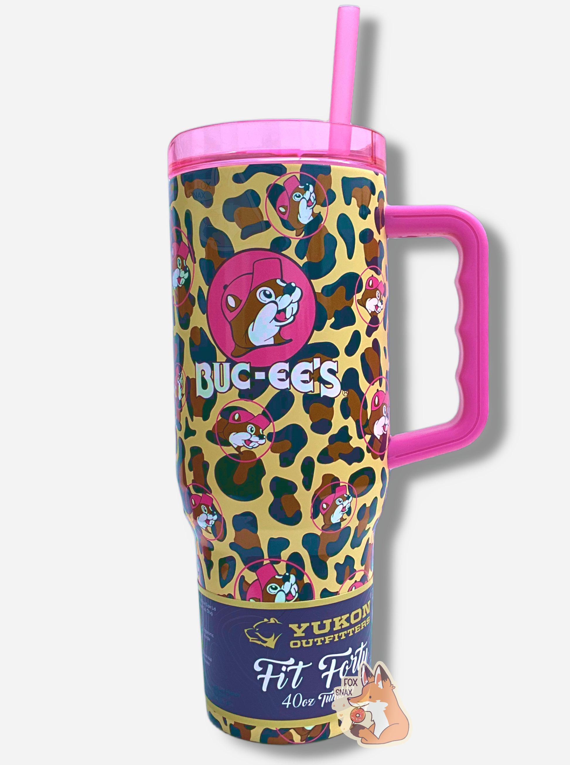 A picture of a tall, pink and leopard print, sorta skinny tumbler, with a big picture of Buc-ee The Beaver on it.  Buc-ee's hat, and the circle behind him, is in hot pink.  The surface is a leopard print, as it is matte paint in leopard colors covering stainless steel.  The handle, top, and straw are hot pink and plastic.  A paper wrapper around the bottom reads: Yukon Outfitters.  Fit Forty 40 oz Tumbler.