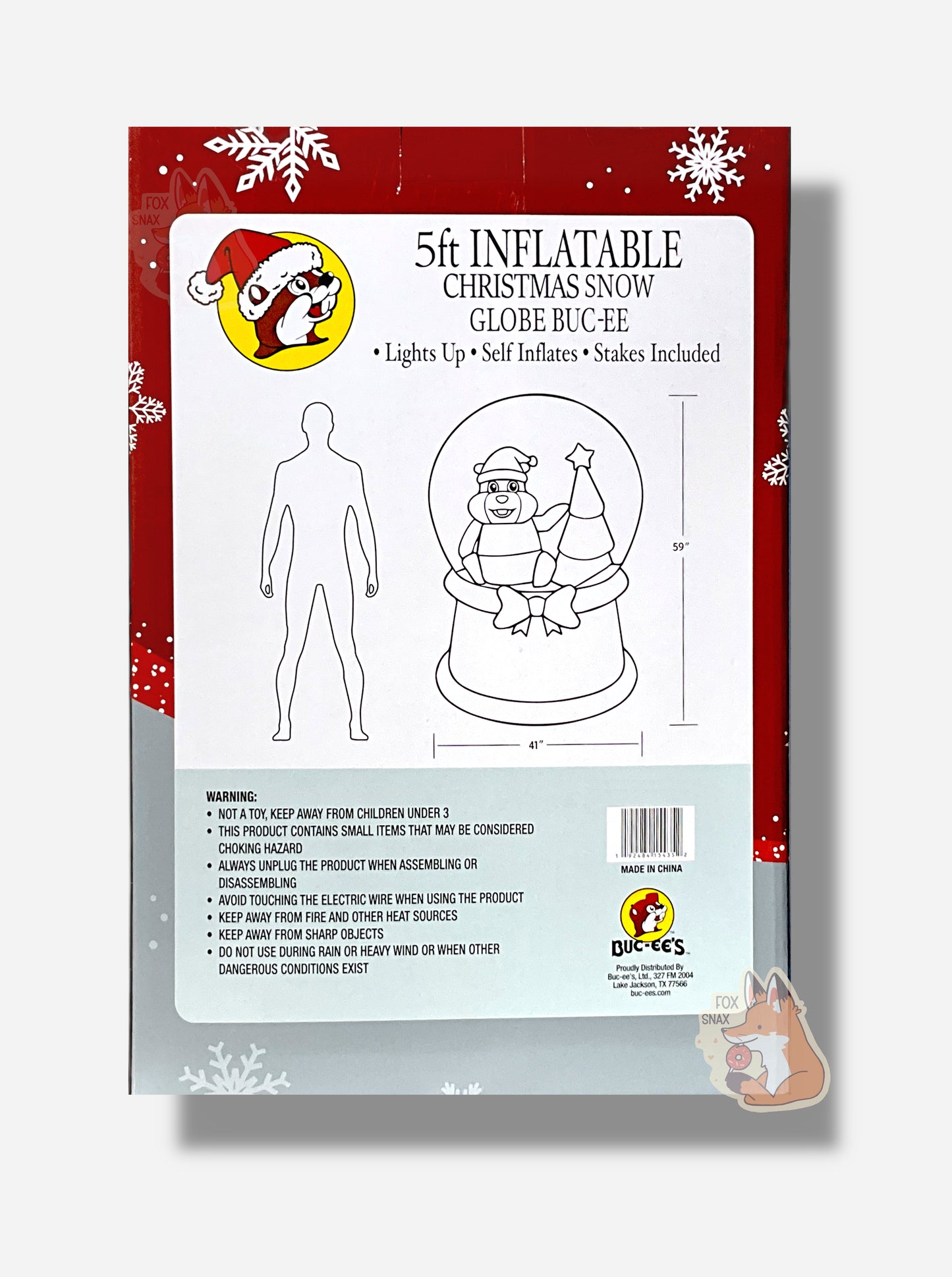 A large rectangular box with a diagram of a 5 foot, inflatable Buc-ee Snoon it. There is an outline diagram of a man, slightly taller than the globe.  The box reads: 5 ft Inflatiable.  Christmas Snow Globe Buc-ee.  Lights up. Self Inflates. Stakes Included.  There are various warnings indicating product is dangerous to small childrendue to  choking hazards, care should be taken near electricity, should be kept away from fire/sharp objects, should not be used when rain, heavy wind, or other conditions exist.
