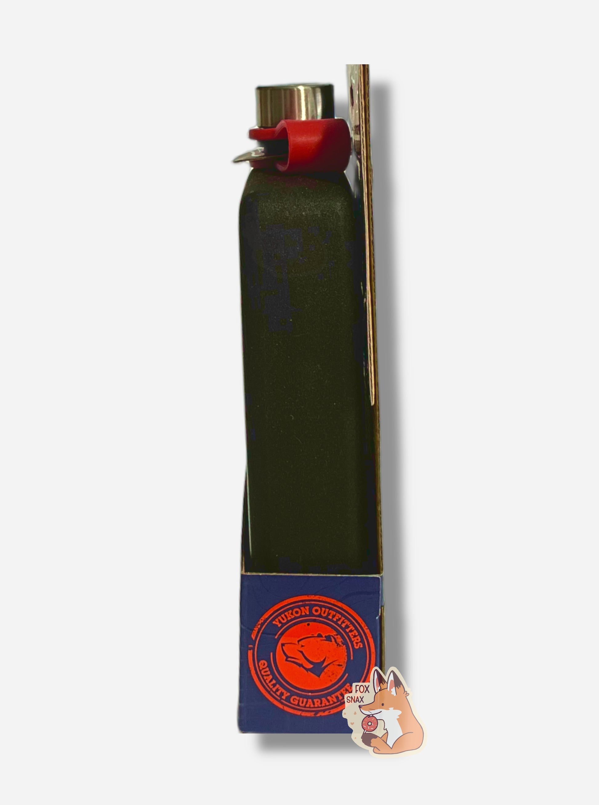 A picture of the right side of a short rectangular, black painted flask. The labeling on the cardboard wrapping shows a red circle that reads YUKON OUTFITTERS QUALITY GUARANTEE in red, circling around the Yukon Outfitters logo - a grumpy looking bear