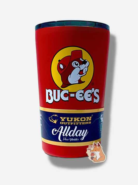 A picture of small 14oz tumbler, with a giant Buc-ee The Beaver logo on the side; he's framed by a yellow background, and is wearing a red ball cap.  The surface of the cup is red paint over metal.  The top of the cup features a black plastic lid.  The bottom surface is black plastic, and acts as a nice grippy surface so the cup doesn't slide around.