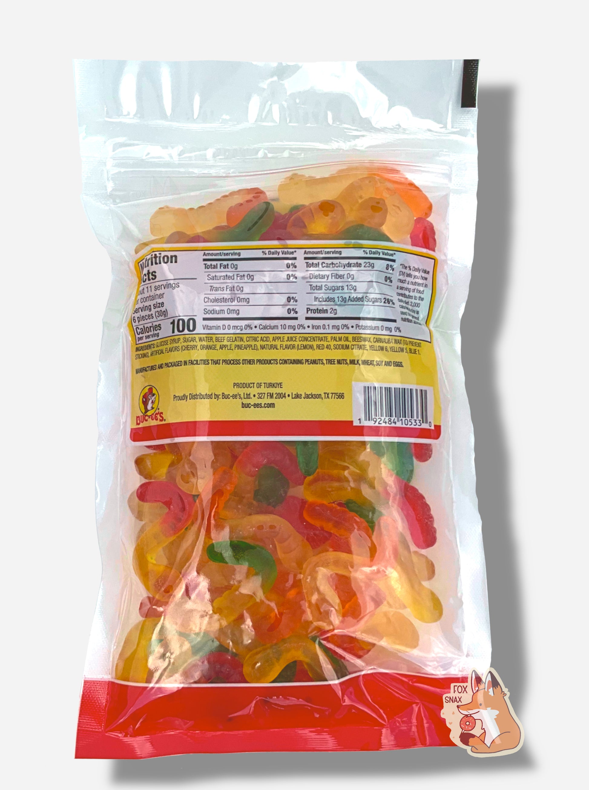 A picture of the back of a resealable bag of Buc-ee's Gummi Worms, which are brightly colored gummi worms in several different bright colors.  The worms inside are multicolored - red-yellow, orange-yellow, and green-yellow.  Nutrition facts, then ingredients are listed.