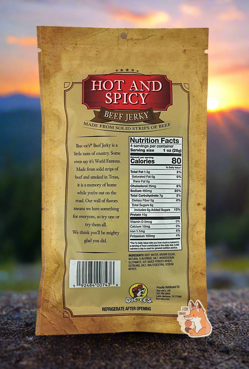 A picture of the back of a tan plastic bag of Buc-ee's Hot And Spicy Beef Jerky.  The label underneath reads 'Buc-ee's Beef Jerky is a little taste of country.  Some even say it's World Famous.  Made from solid strips of beef and smoked in Texas, it is a memory of home while you're out on the road.  Our wall of flavors means we have something for everyone, so try one or try them all.  We think you'll be mighty glad you did.'  The background shows a campground with a beautiful sunset.