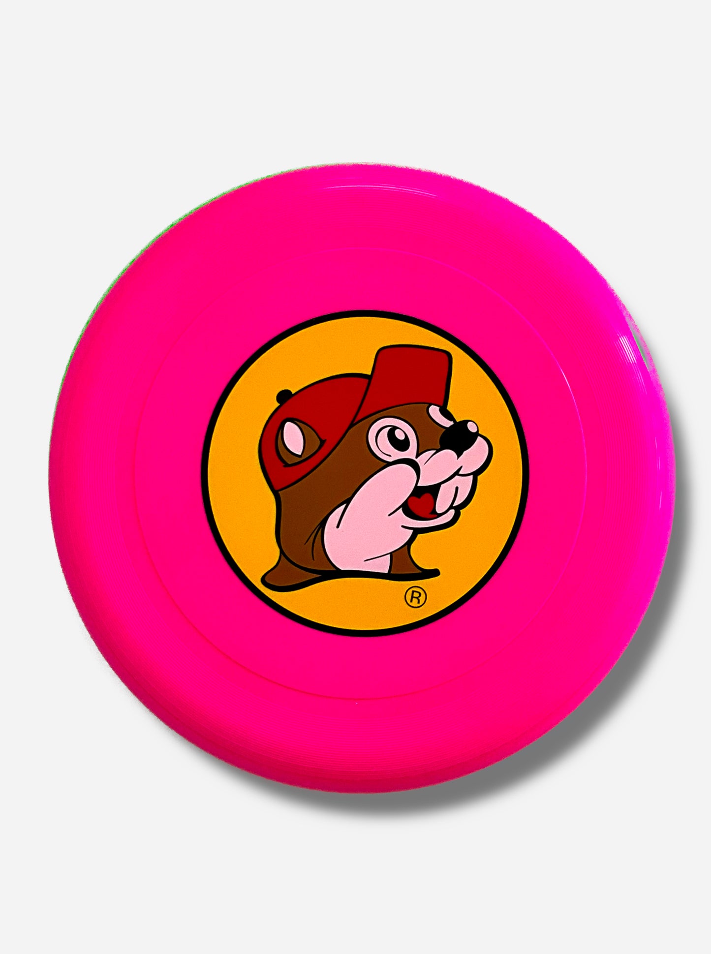 A picture of the top of a large, hot pink flying disc toy.  In the center of the toy is a large circular picture of Buc-ee The Beaver, grinning, against a yellow background.  He is wearing a red ball cap.