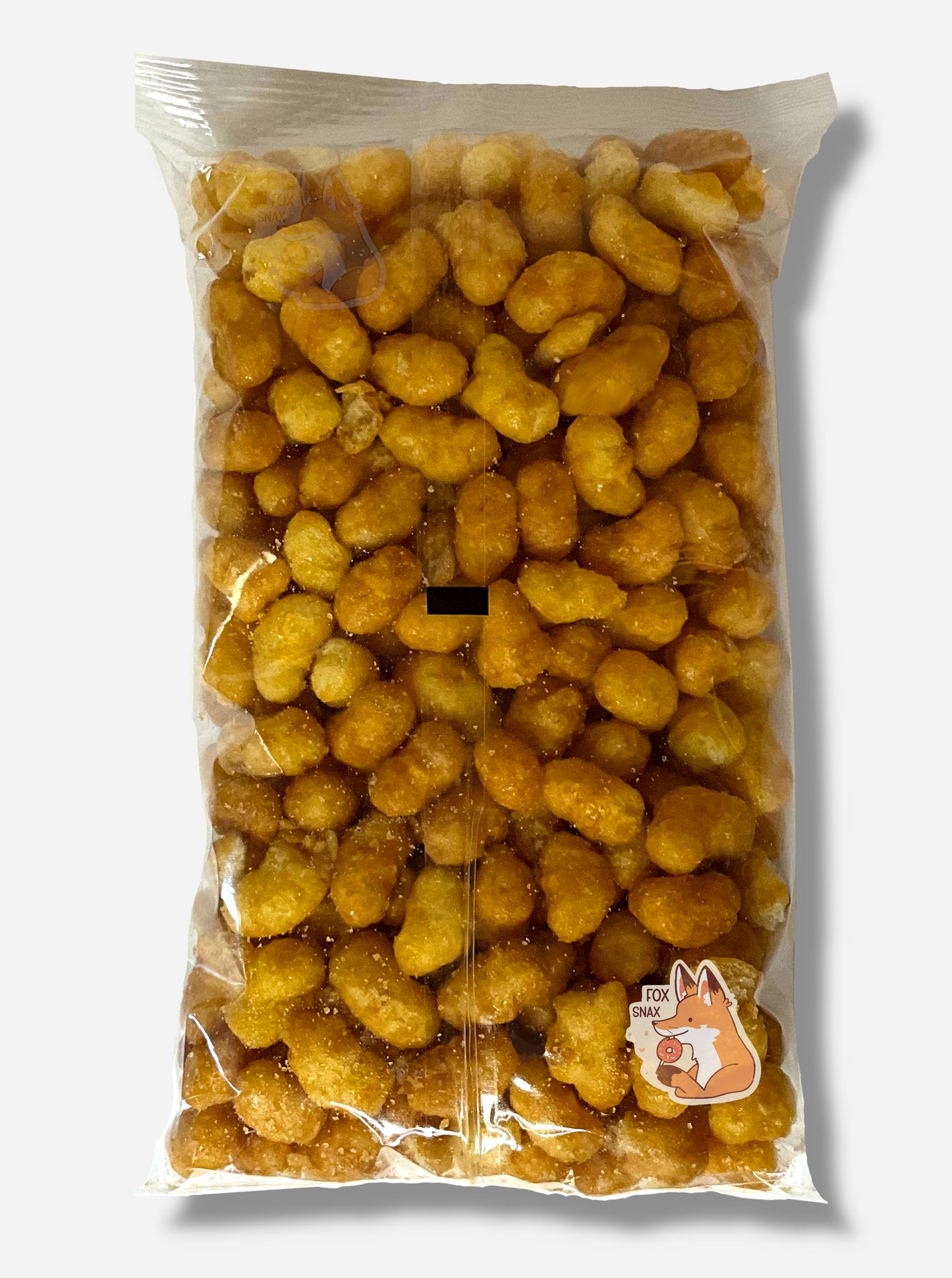 A picture of the back of a clear plastic bag of Buc-ee's Beaver Nuggets, which are a puffed corn snack with caramel flavors.