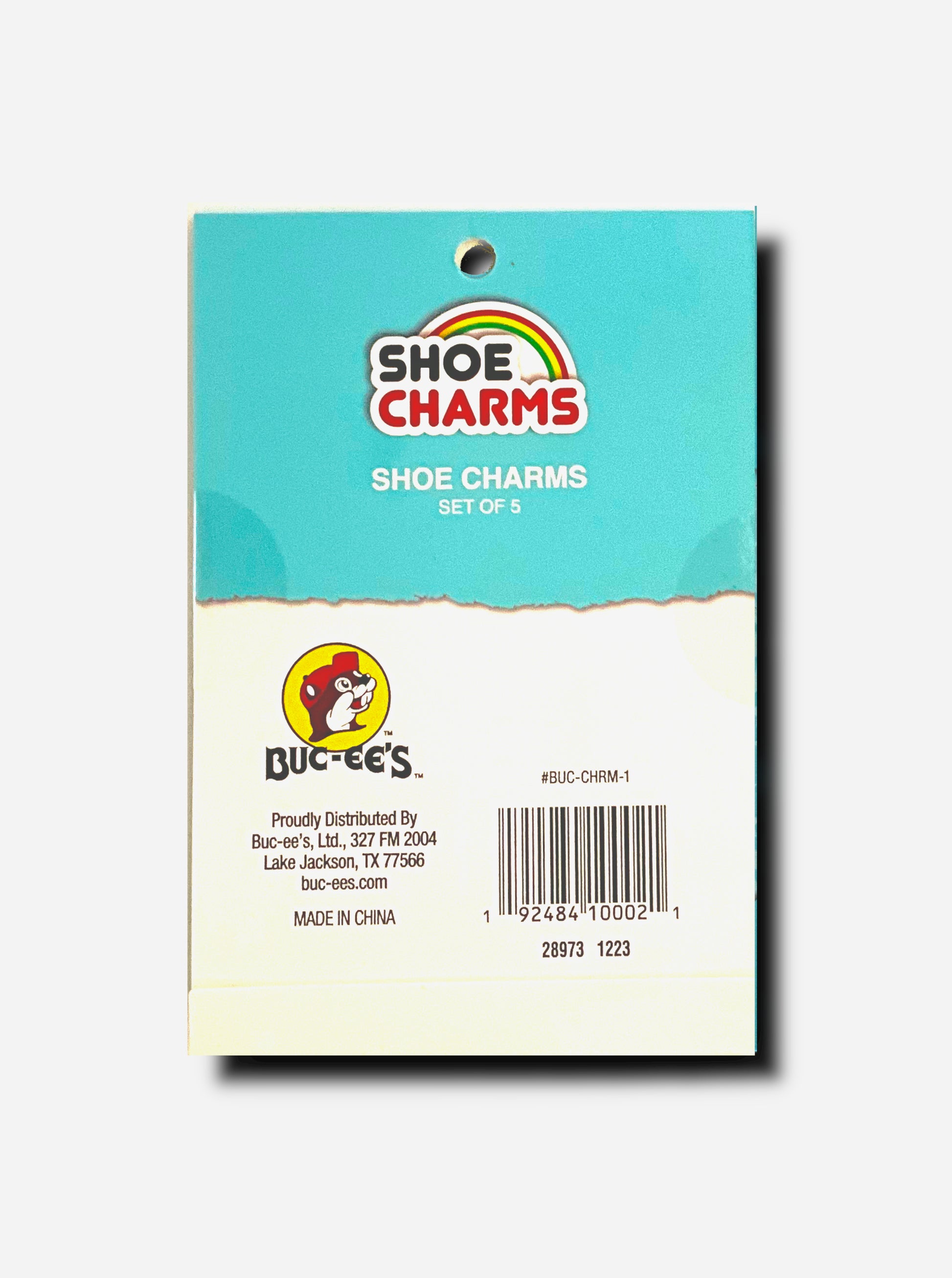 A picture of the back of a set of 5 shoe charms from Buc-ee's.  Top of package is light blue and reads: SHOE CHARMS, SET OF 5.