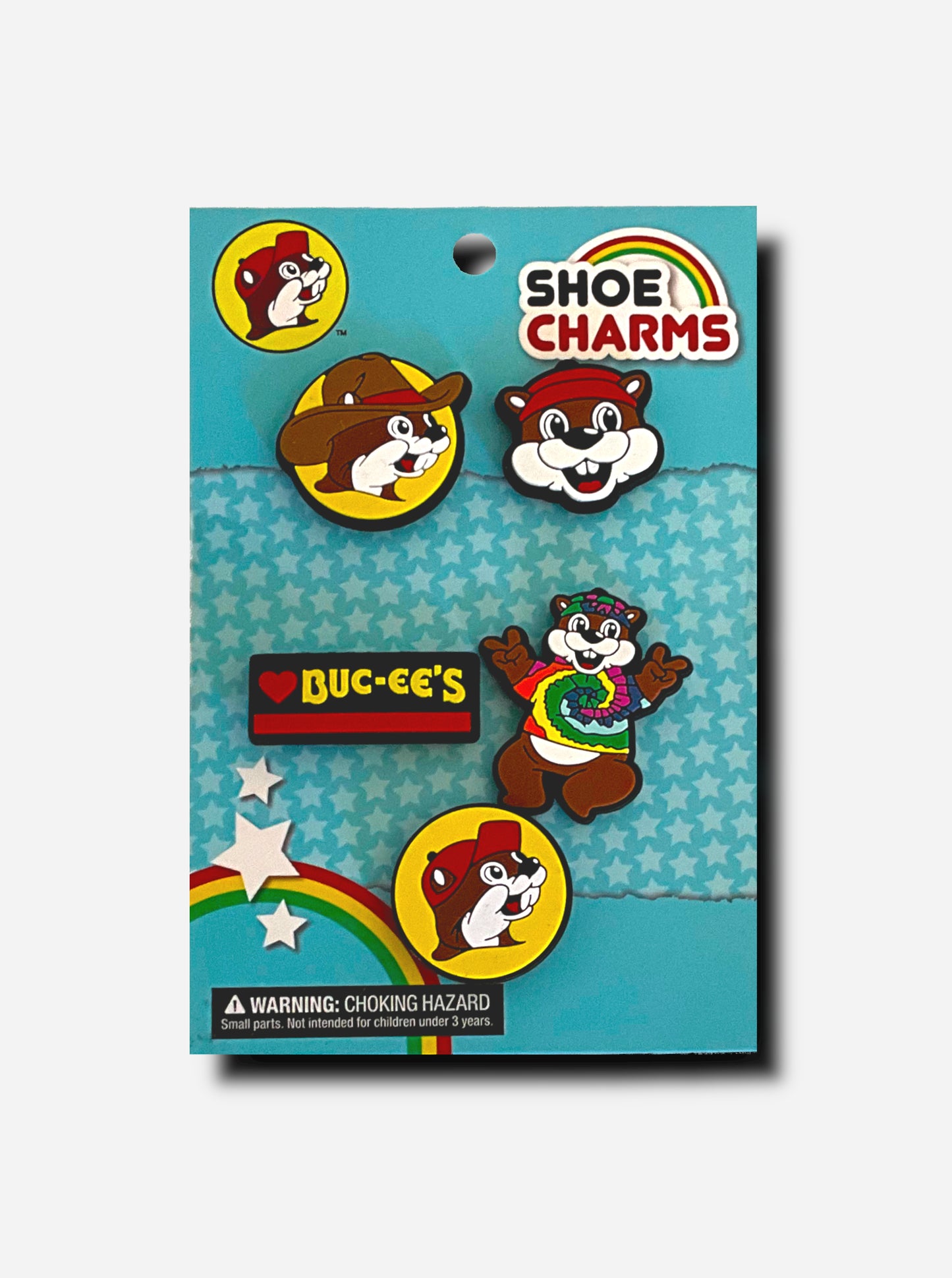 A picture of a set of 5 shoe charms from Buc-ee's:  clockwise from top left, a picture of Buc-ee the Beaver wearing a cowboy hat with a red stripe, a front-facing Buc-ee the Beaver, a full body Buc-ee The Beaver wearing a tie dye hat and t-shirt, the standard Buc-ee's logo with Buc-ee wearing a red ball cap, and a rectangular black sign that reads: <heart> BUC-EE'S.