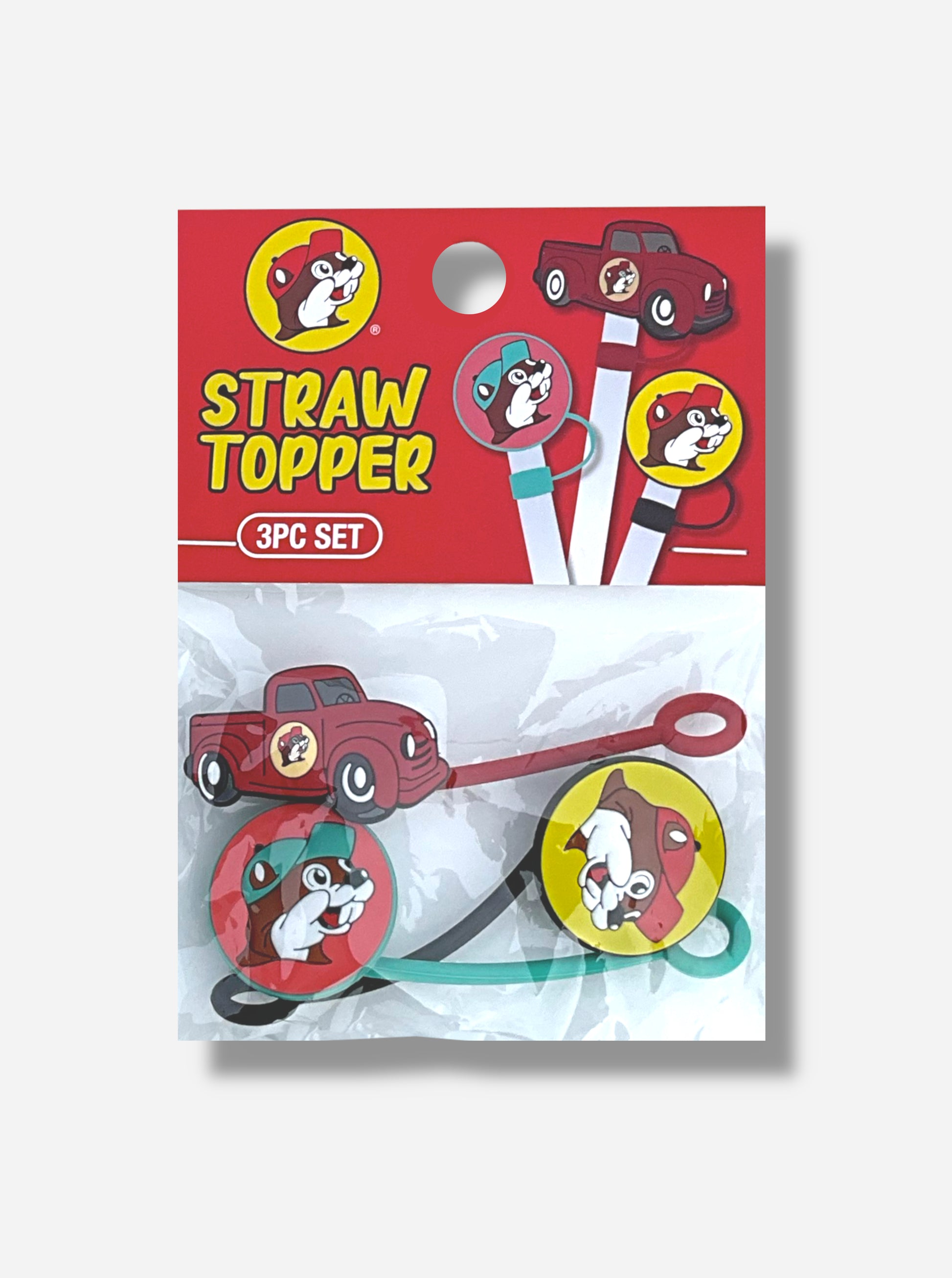 A picture of a small plastic bag.  The top of the bag has a red cardboard top  that reads "STRAW TOPPER", then "3PC Set".  There is a picture of each of the 3 plastic straw toppers on the top and in the bag.  The first topper is the Buc-ee's logo: a cheerful beaver wearing a red ball cap against a yellow background.  The second is a red pickup truck with the Buc-ee's logo.  The third is the Buc-ee's logo, but the cap is green/blue and the background red.