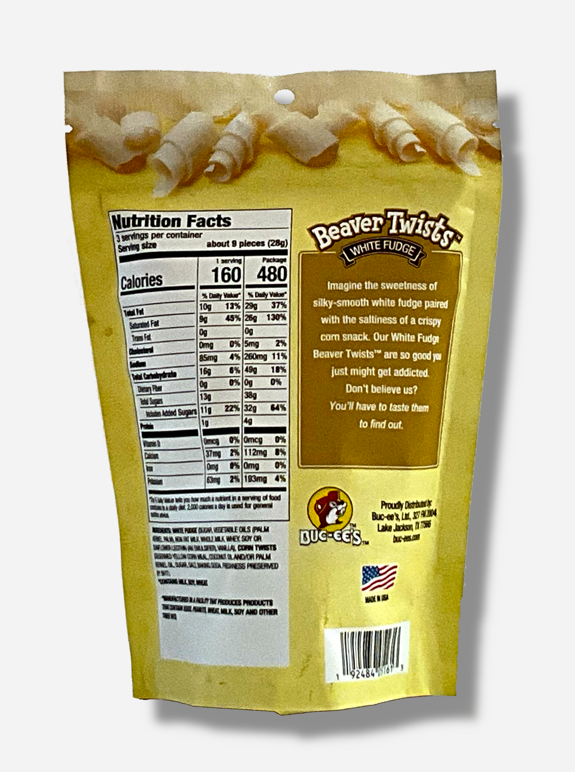 A picture of the back of a slightly metallic yellow bag, The back of the bag reads: "Imagine the sweetness of silky-smooth white fudge paired with the saltiness of a crispy corn snack.  Our White Fudge Beaver Twists are so good you just might get addicted.  Don't believe us? You'll have to taste them to find out."The top of the bag has pictures of curls of white fudge, the bottom of the bag has pictures of the twists themselves: cone-shaped corn treats covered in white fudge.