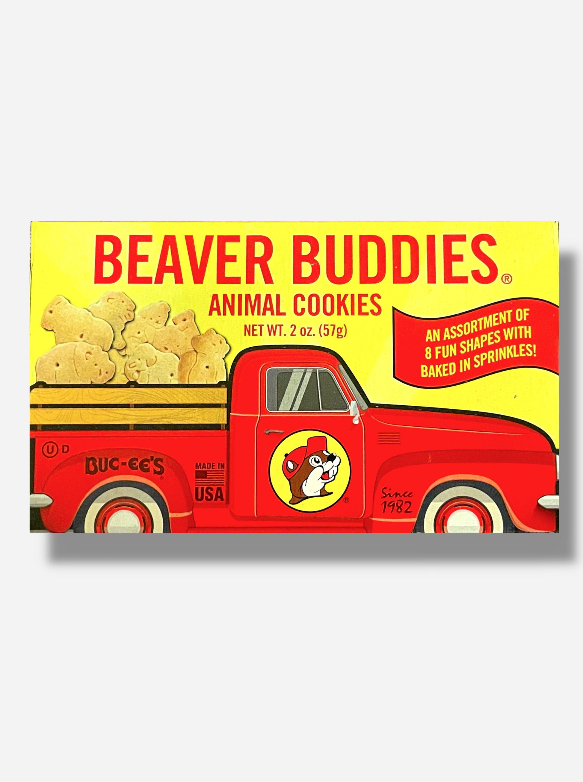 The front of a small rectangular cardboard package of Buc-ee's Beaver Buddies Animal Cookies.  The label has a picture of a red truck with the Buc-ee The Beaver logo on the door panel, and a series of animal cookies in the bed of the truck.  The text reads BEAVER BUDDIES ANIMAL COOKIES, NET WT 2 oz (57g).  AN ASSORTMENT OF 8 FUN SHAPES WITH BAKED IN SPRINKLES!  Made in the USA.