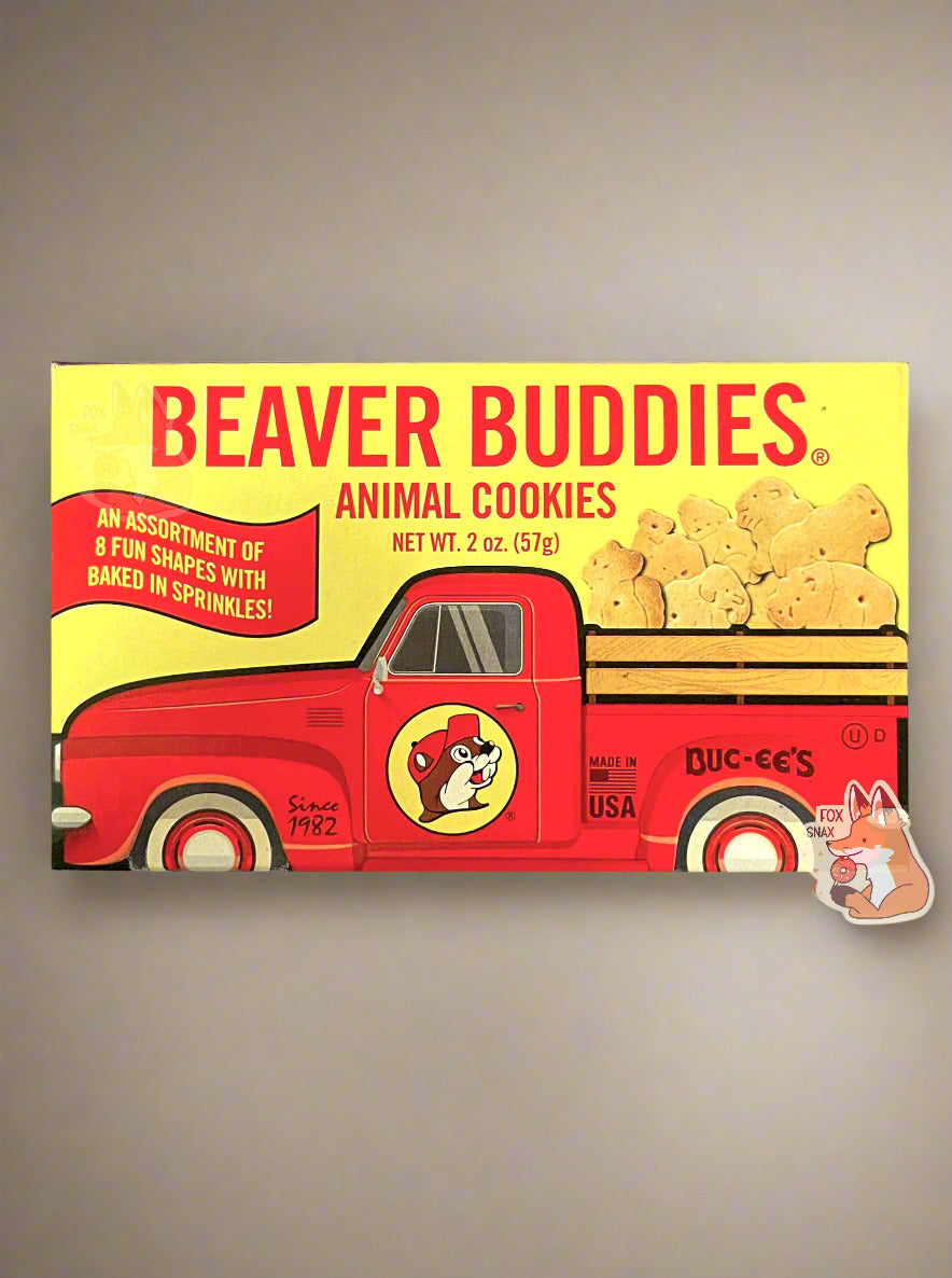 The back of a small rectangular cardboard package of Buc-ee's Beaver Buddies Animal Cookies.  The label has a picture of a red truck with the Buc-ee The Beaver logo on the door panel, and a series of animal cookies in the bed of the truck.  The text reads BEAVER BUDDIES ANIMAL COOKIES, NET WT 2 oz (57g).  AN ASSORTMENT OF 8 FUN SHAPES WITH BAKED IN SPRINKLES!  Made in the USA.  The background is of a clean kitchen counter.