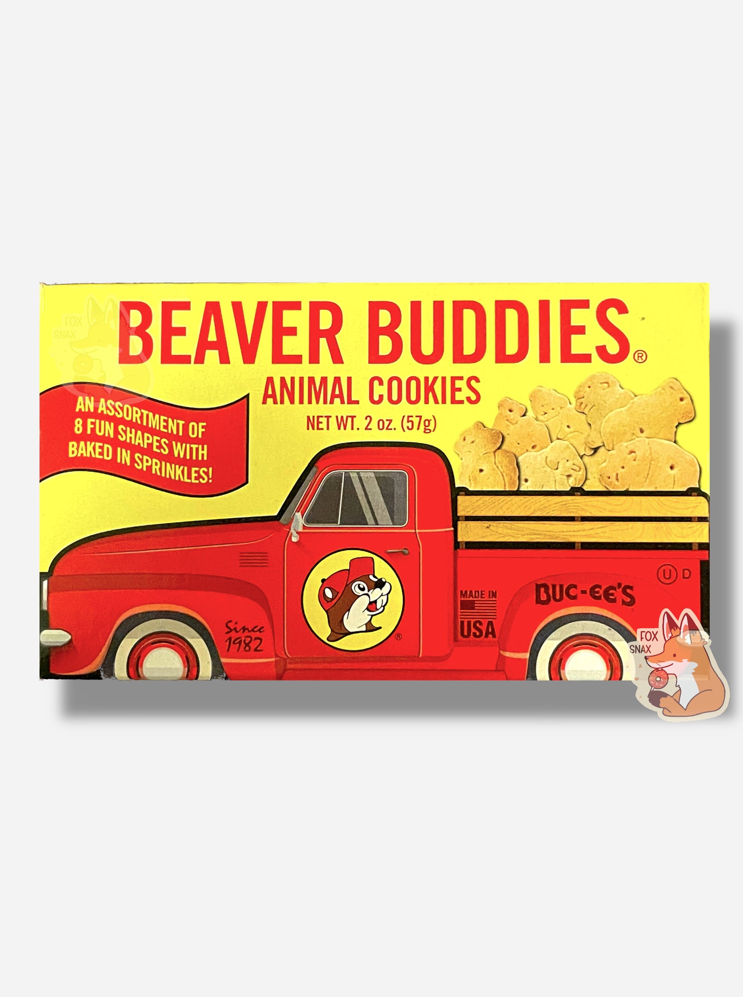 The back of a small rectangular cardboard package of Buc-ee's Beaver Buddies Animal Cookies.  The label has a picture of a red truck with the Buc-ee The Beaver logo on the door panel, and a series of animal cookies in the bed of the truck.  The text reads BEAVER BUDDIES ANIMAL COOKIES, NET WT 2 oz (57g).  AN ASSORTMENT OF 8 FUN SHAPES WITH BAKED IN SPRINKLES!  Made in the USA.