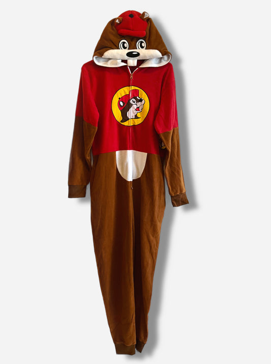 A picture of a large onesie that resembles Buc-ee The Beaver.  The hood is Buc-ee's beaver head, complete with fuzzy brown ears, adorable eyes, and red ball cap.  A pair of white beaver teeth is present on the top of the hood.  The chest of the hoodie has a zipper down the front, and is colored like a red Buc-ee's shirt, complete with the Buc-ee's logo on it.  The legs and arms are brown cloth "fur", and a white belly can be seen.