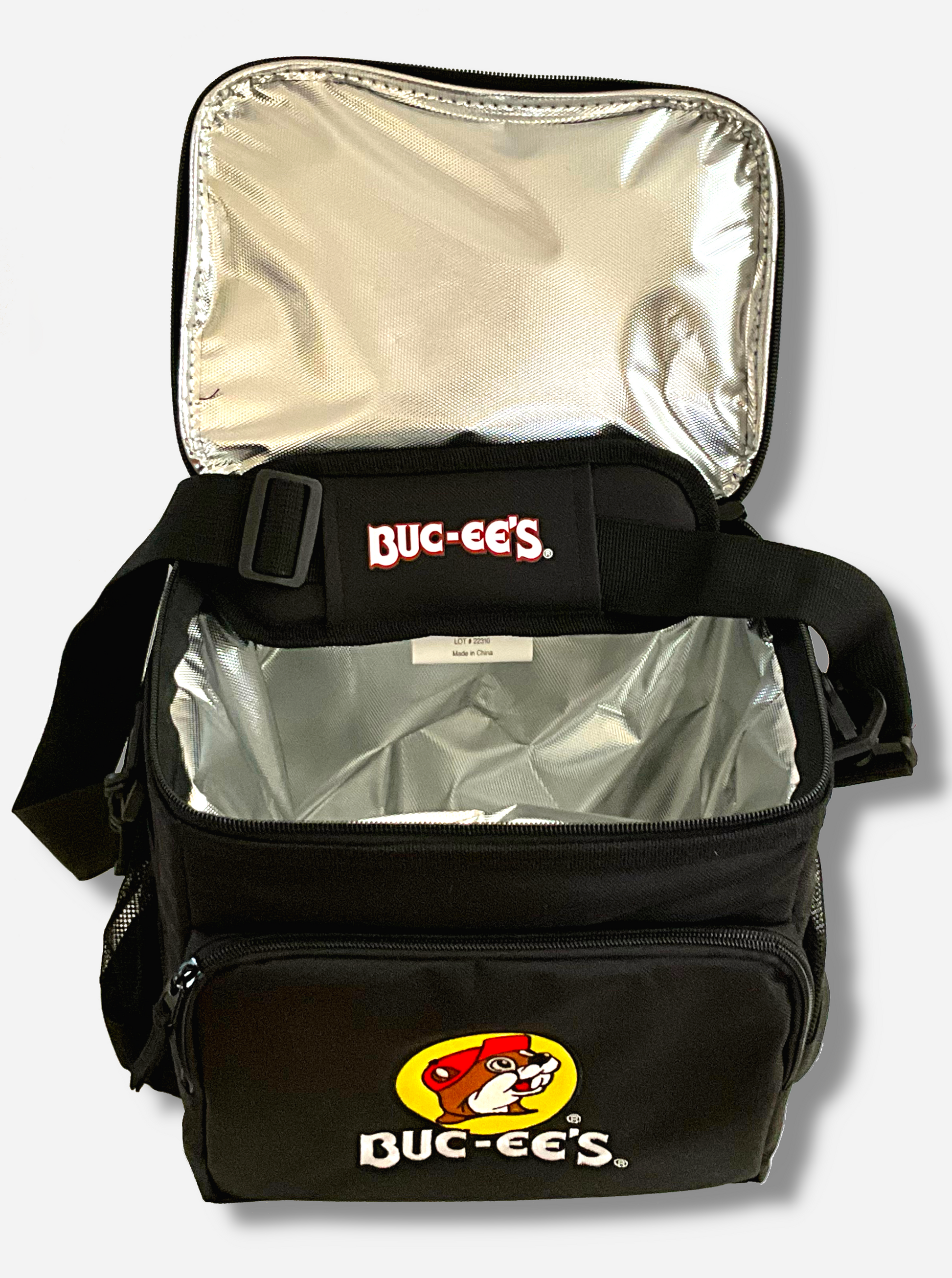 A picture of the front of a large lunch box cooler.  The outer surface is made of black polyester, and has a large black strap on it that reads BUC-EE'S.  The front of the total has a zip pouch, with the Buc-ee's logo on it: a grinning beaver wearing a red hat against the background of a yellow circle.  The sides of the tote has mesh pouches, the top opened to show the liner, a foil composite inside.