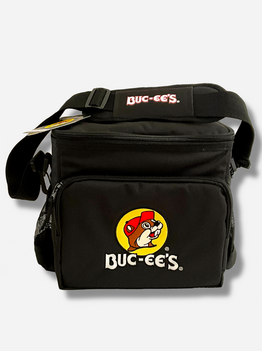 A picture of a three-quarters view of the front of a lunch box cooler.  The outer surface is made of black polyester, and has a large black strap on it that reads BUC-EE'S.  The front of the lunch box has a zip pouch, with the Buc-ee's logo on it: a grinning beaver wearing a red hat against the background of a yellow circle.  The sides of the tote has mesh pouches, the top sealed by a zipper.