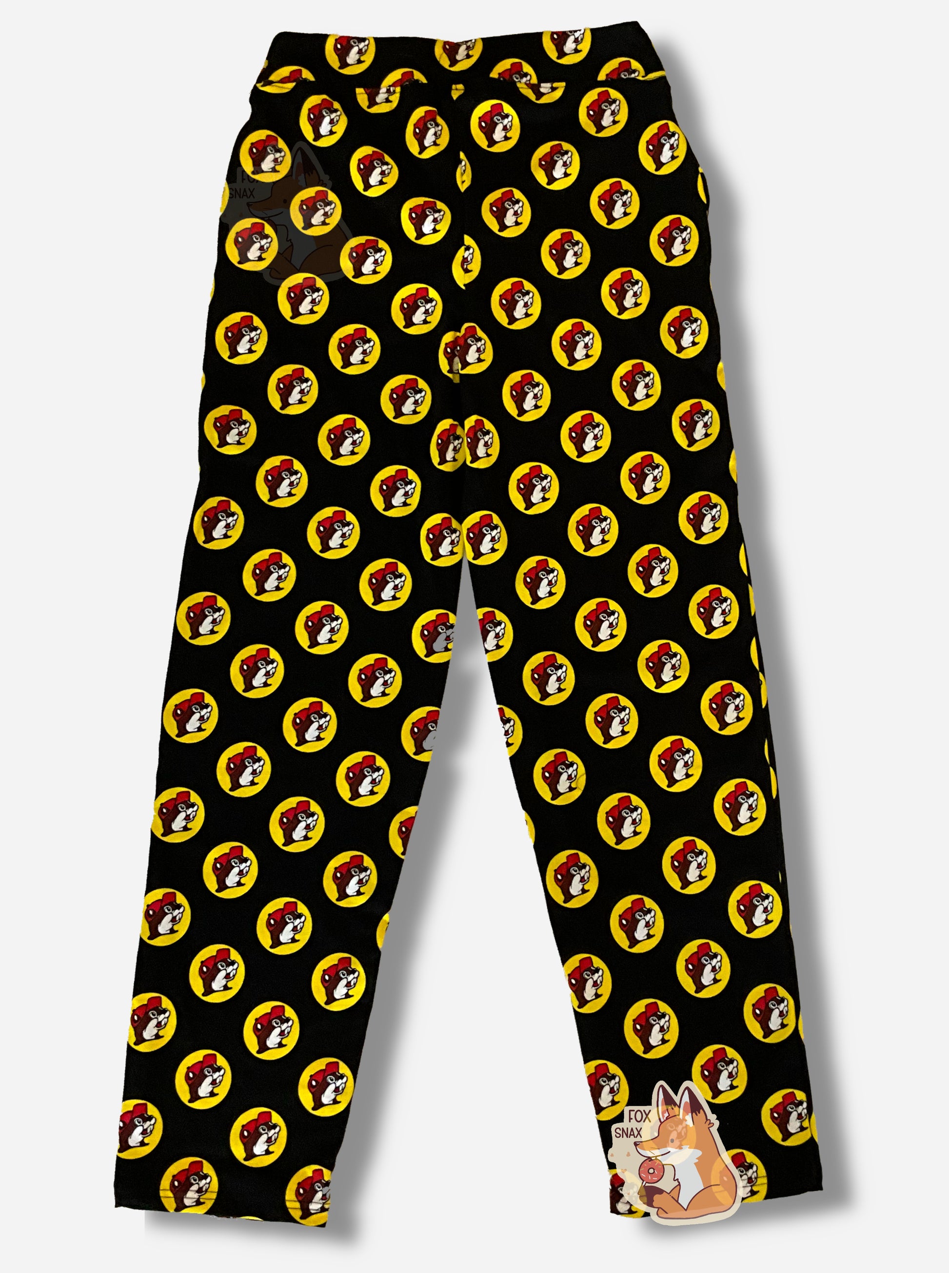 A picture of a pair of black pants.  The pants are covered in Buc-ee's logos: a grinning beaver wearing a red ballcap, backlit by a yellow circle.  