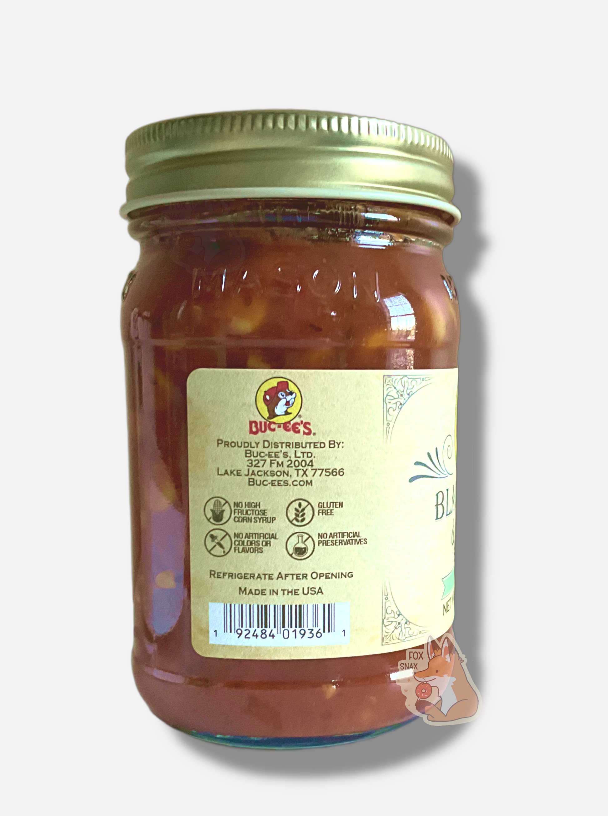 A picture of the left side of a glass jar of Buc-ee's Black Bean & Corn Salsa - the label is a "old-timey" sort of white/yellow with flared edges.  The middle reads No High Fructose Corn Syrup, No Artificial Colors Or Flavors, Gluten Free, No Artificial Preservatives. In the jar, dark red salsa can be seen.
