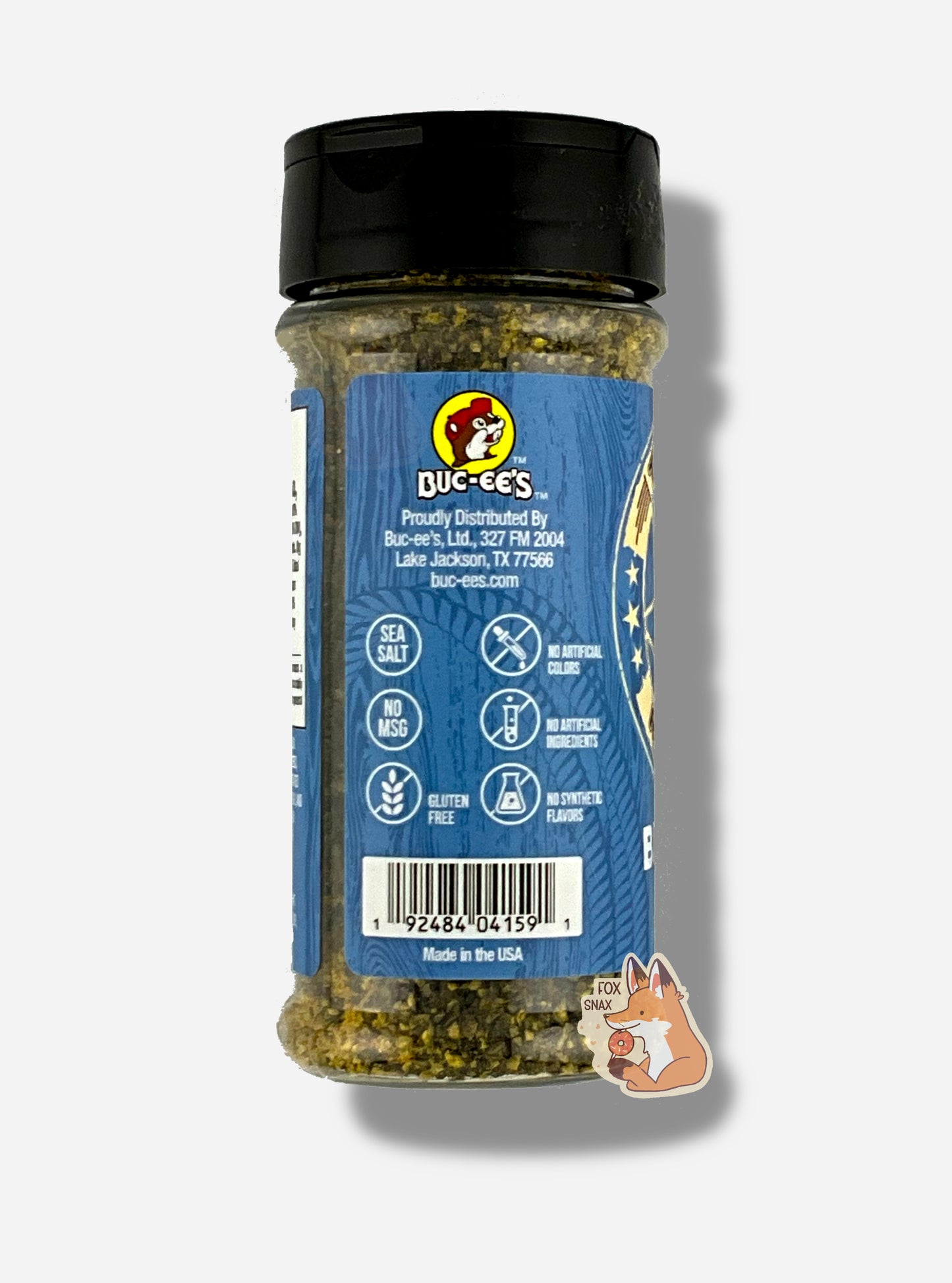 A picture of the side of a container of Texas Round Up Brisket Rub.  The container has a black plastic flip lid, and a clear plastic body.  The spices inside appear grey and black.  The blue label reads SEA SALT, NO MSG, GLUTEN FREE, NO ARTIFICIAL COLORS, NO ARTIFICIAL INGREDIENTS, NO SYNTHETIC FLAVORS.  Beneath that, MADE IN THE USA