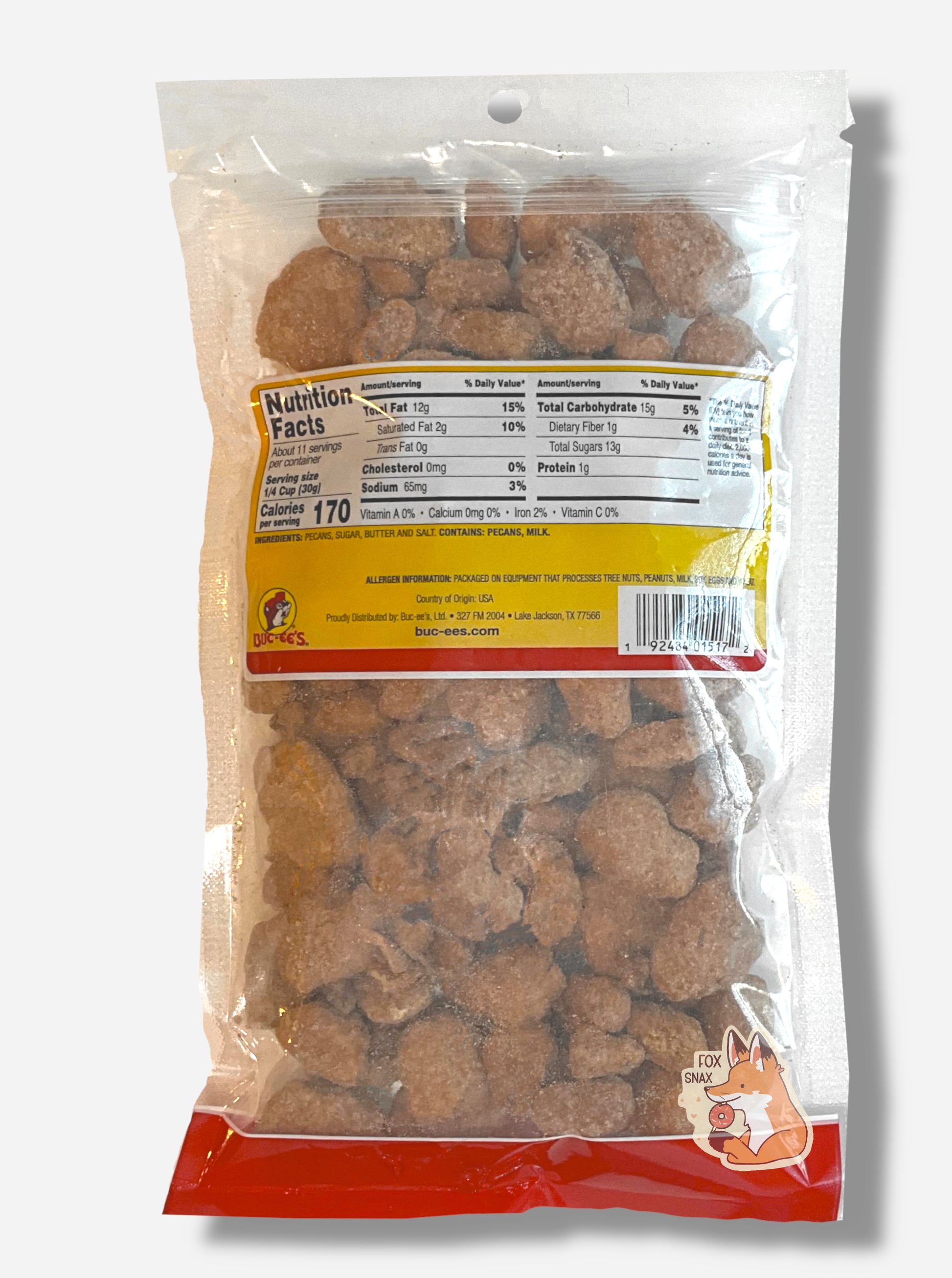 A picture of the back of a clear plastic bag of Buc-ee's Butter Toffee Pecans.  Inside the bag are a large number of dried pecans, covered in brownish butter toffee  material.