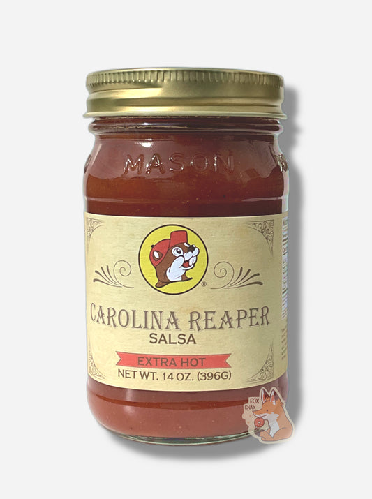 A picture of the front of a glass jar of Buc-ee's Carolina Reaper Salsa (Extra Hot)  - the label is a "old-timey" sort of white/yellow with flared edges.  The middle has a giant Buc-ee the Beaver logo on it.  In the jar, reddish salsa can be seen.  On the bottom, a red banner reads EXTRA HOT.