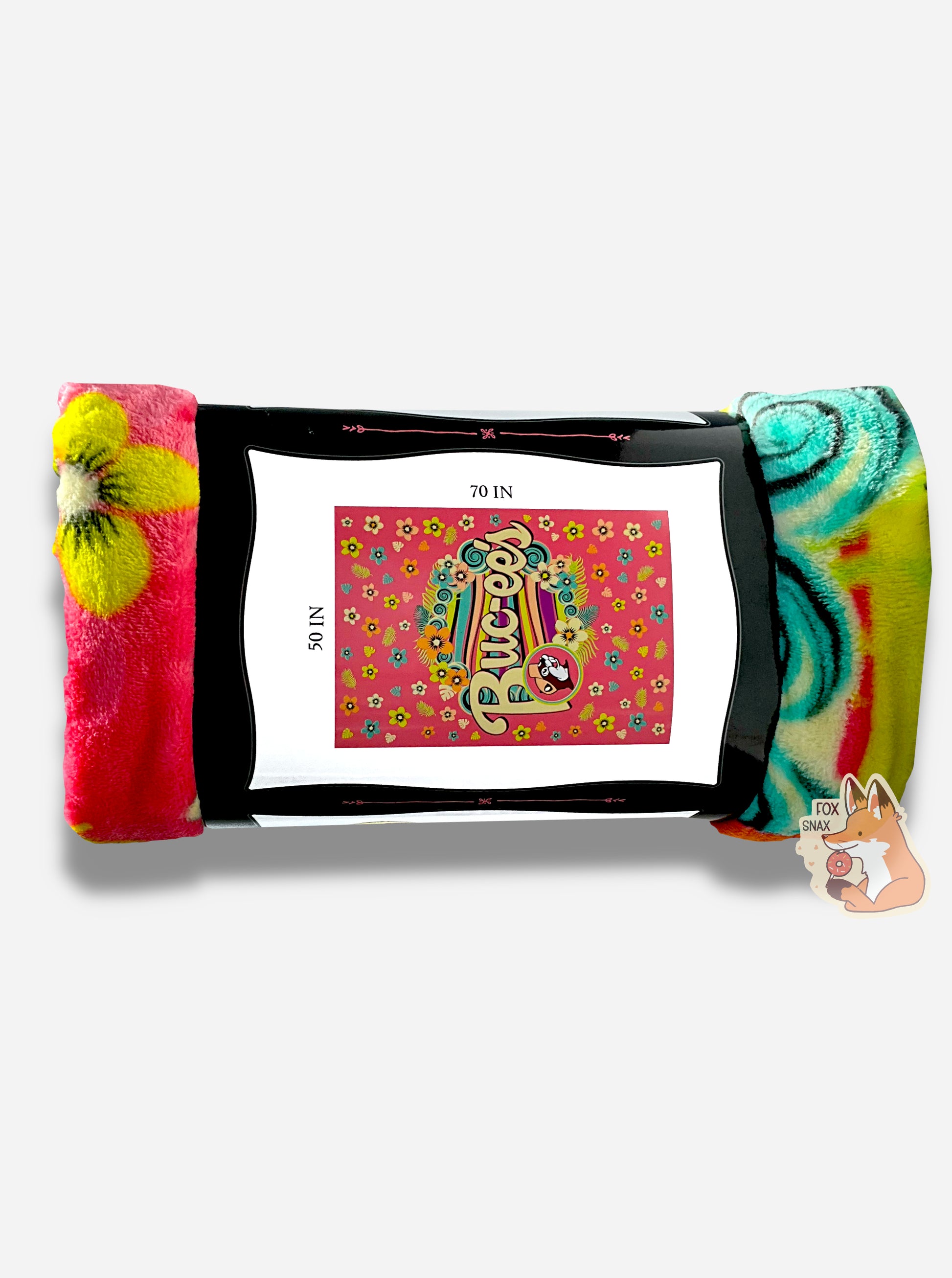 A picture of the other side of a rolled up blanket.  The blanket is a multicolored (pink, yellow, orange, black, green/blue) blanket with pastel florals and a wave of soothing colors through the center. The iconic beaver makes an appearance, rocking a pink cap, with curvy white Buc-ee's text to match.  The paper label surrounding the blanket reads BUC-EE'S BLANKET *SOFT AND COMFY* 50 IN x 70 IN  