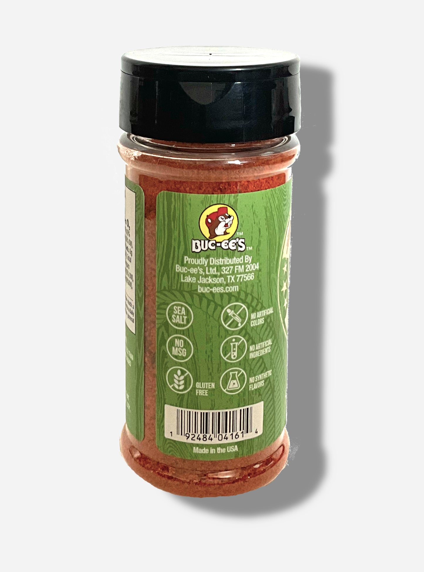 A picture of the side of a container of Texas Round Up Fajita Seasoning.  The container has a black plastic flip lid, and a clear plastic body.  The spices inside appear red and orange.  The green label reads SEA SALT, NO MSG, GLUTEN FREE, NO ARTIFICIAL COLORS, NO ARTIFICIAL INGREDIENTS, NO SYNTHETIC FLAVORS.  Beneath that, MADE IN THE USA