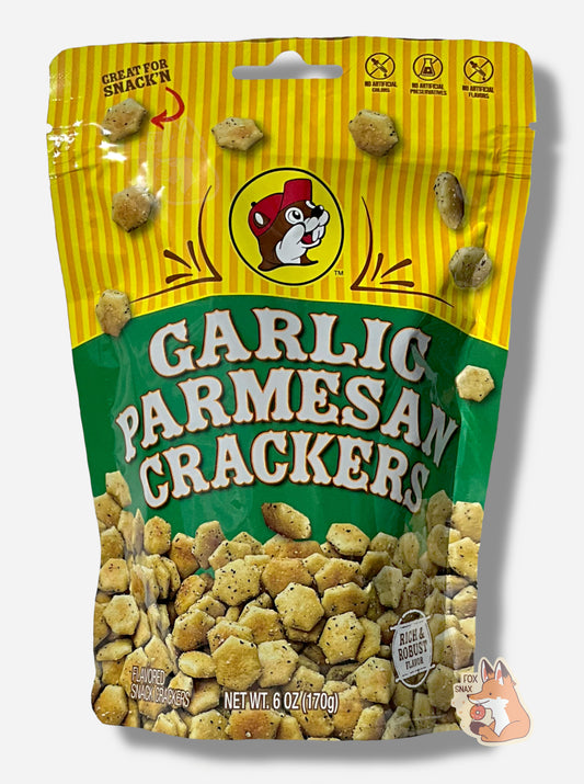 A picture of a metallic bag of Buc-ee's Garlic Parmesan Crackers.  The logo is a green background on white text; a large number of savory-looking hexagonal oyster crackers are shown beneath it.  At the top is a picture of the logo of Buc-ee The Beaver, and it reads GREAT FOR SNACK'N, NO ARTIFICIAL COLORS, NO ARTIFICIAL PRESERVATIVES, NO ARTIFICIAL FLAVORS and RICH AND ROBUST FLAVOR