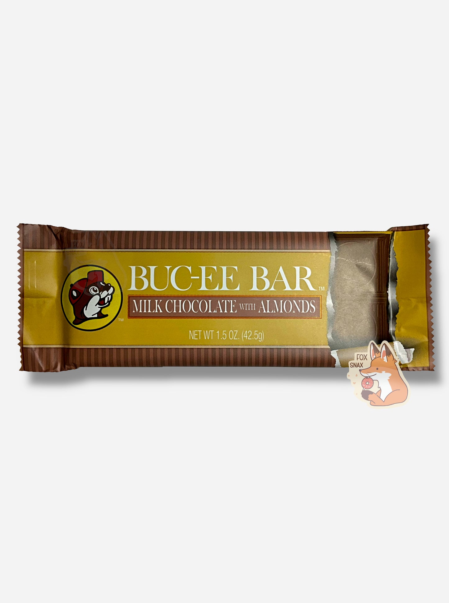 A picture of a rectangular bar of a Buc-ee Bar.  The package reads BUC-EE BAR, then MILK CHOCOLATE WITH ALMONDS.  The center part of the bar is a brown/yellow, with the Buc-ee The Beaver logo on the left.  On the right is a picture of the bar - it shows several squares with the Buc-ee's logo inset.