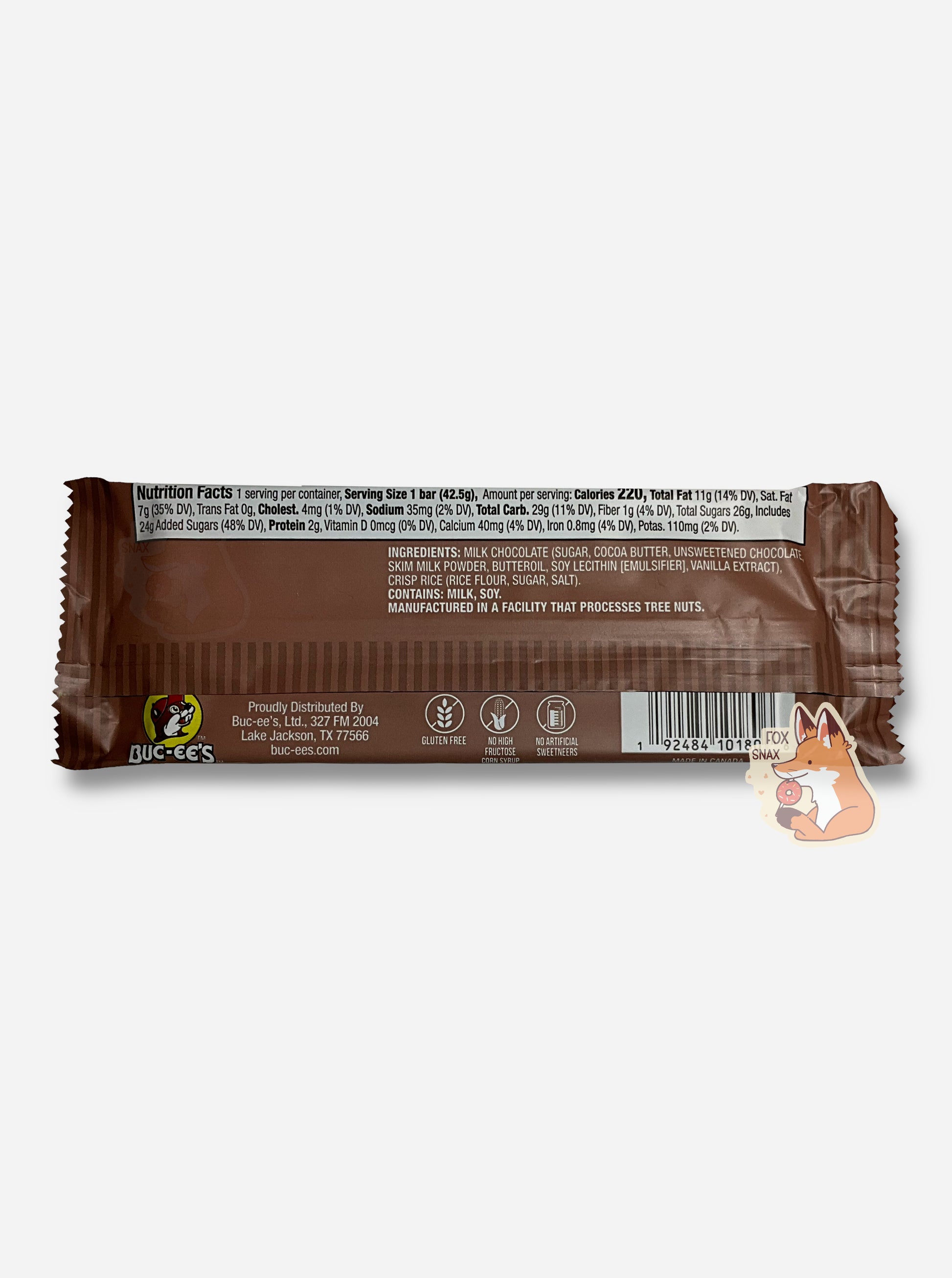 A picture of the back of a rectangular bar of a Buc-ee Bar.  The label is brown, and at the bottom, it reads GLUTEN FREE, NO HIGH FRUCTOSE CORN SYRUP, NO ARTIFICIAL SWEETENERS.