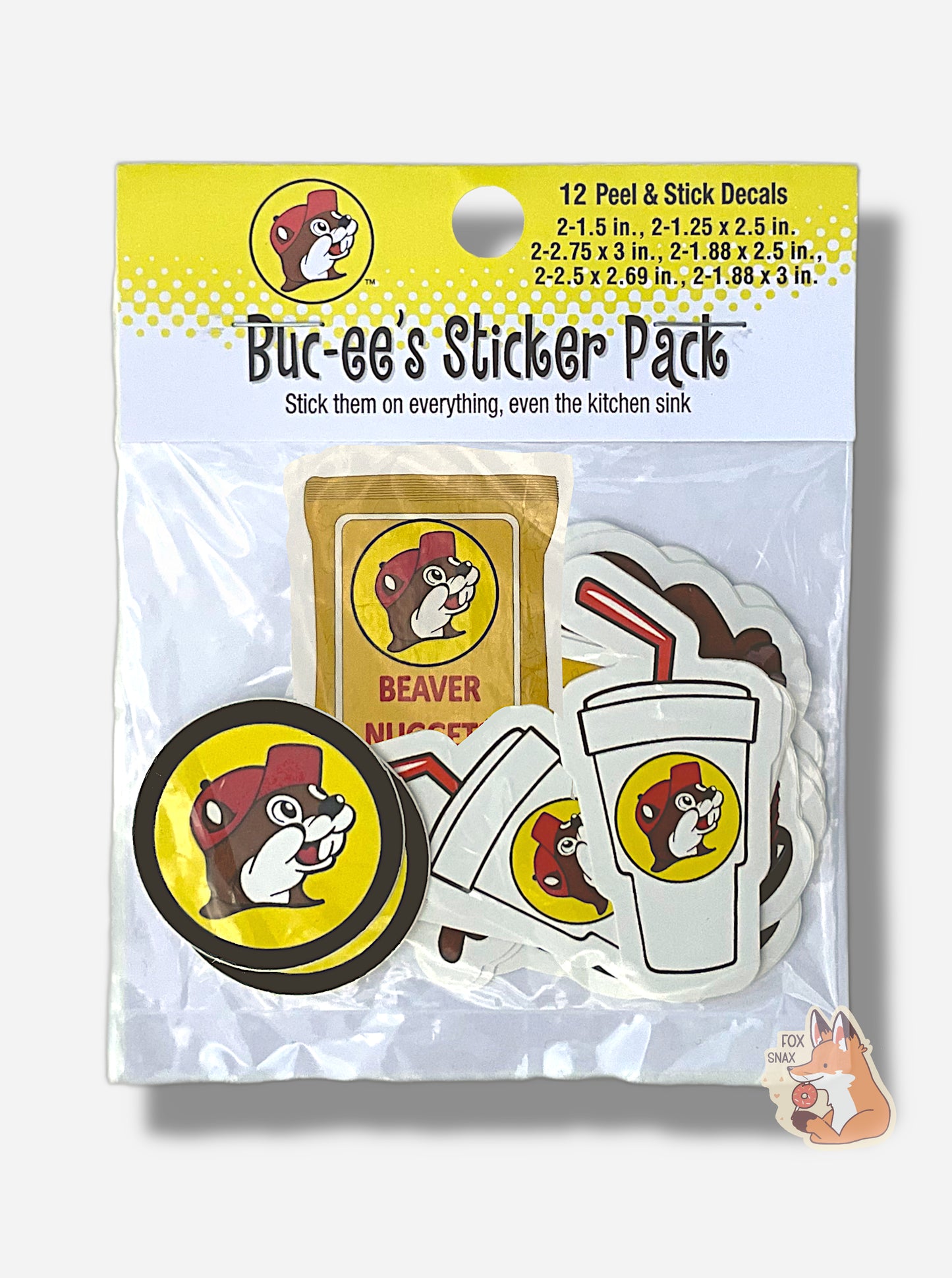 A picture of the front of Buc-ee's Nugget And Drink Sticker Pack.  The cardboard label on the top of the bag indicates there are 12 peel & stick decals inside. The text on the label reads "BUC-EE'S STICKER PACK", then "Stick them on everything, even the kitchen sink".  Inside the bag, you can see two Buc-ee's logos, two drink cups (each with a logo on them and a red straw), a bag of Beaver Nuggets, and several other half-obscured stickers.