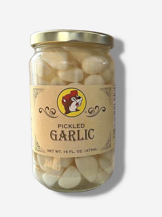 A picture of the front of a glass jar of Buc-ee's Pickled Garlic - the label is a "old-timey" sort of white/yellow with flared edges.  The middle has a giant Buc-ee the Beaver logo on it.  In the jar, floating garlic cloves in an clear brine can be seen.