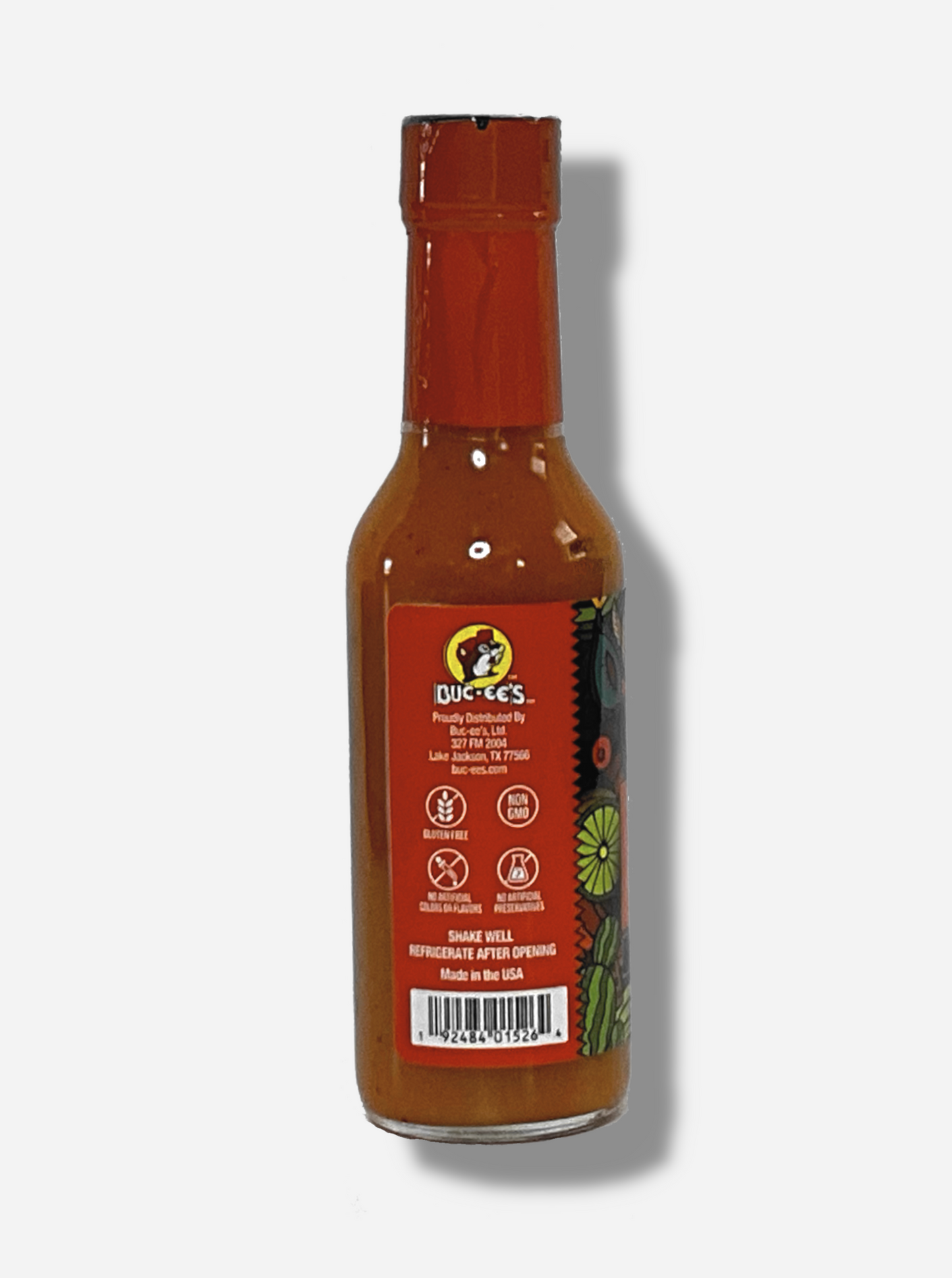 A picture of a small, tall glass bottle of hot sauce. The top of the bottle is sealed with a shiny orange plastic top.  The back reads GLUTEN FREE, NON GMO, NO ARTIFICIAL COLORS OR FLAVORS, NO ARTIFICIAL PRESERVATIVES, then SHAKE WELL and REFRIGERATE AFTER OPENING.  Made in the USA.  The sauce inside is bright orange.