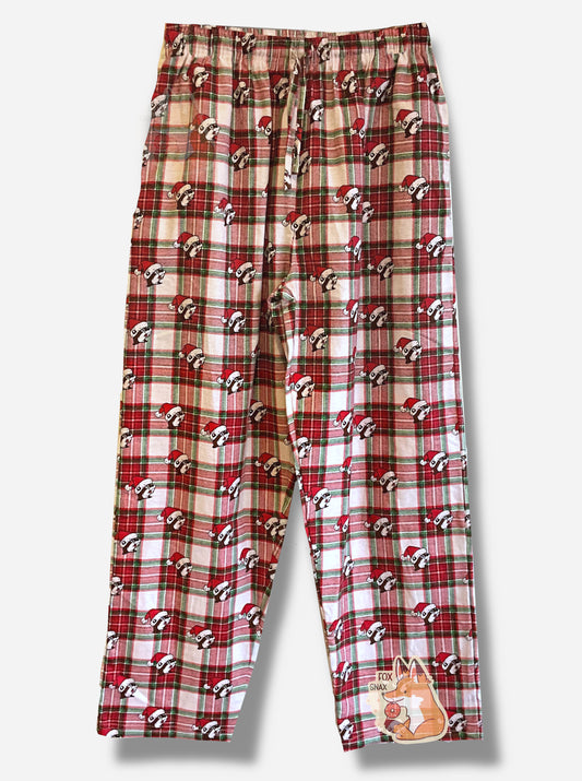 A picture of a plaid pair of Buc-ee's pajama pants.  The pattern is red, white, and green, and is dotted with Buc-ee the Beaver heads.  Each of the heads is wearing a red Santa hat.  The waist has a drawstring, made of the same material as the pants.