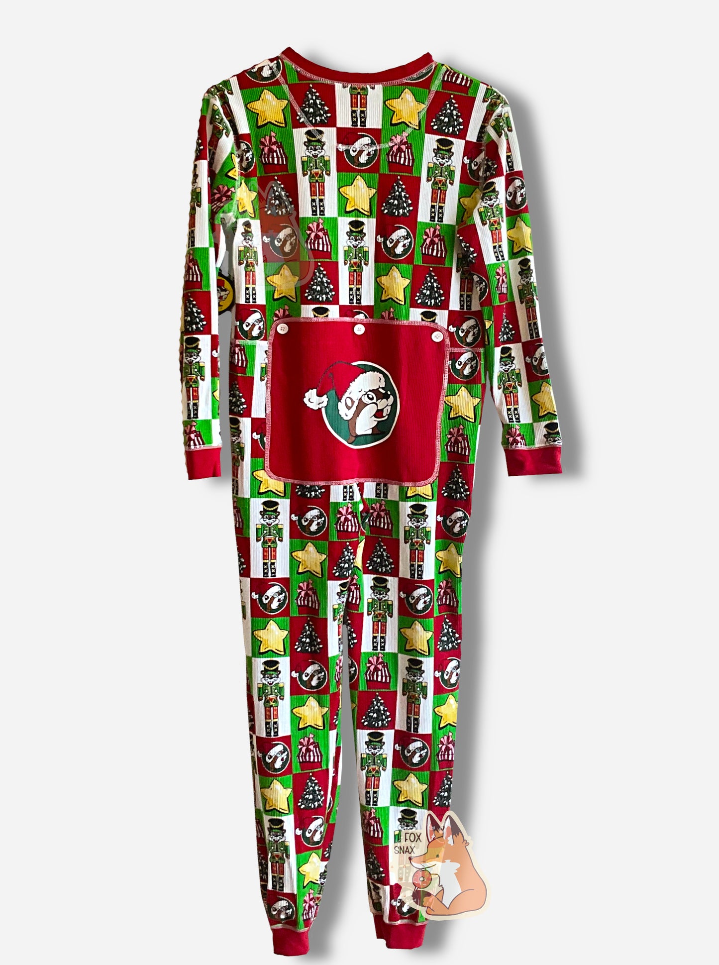 A picture of a large onesie that resembles Christmas wrapping.  Most of the wrapping is separated into squares or rectangles. The shapes have within them, alternately: yellow stars, Christmas trees, red wrapped presents with a pink bow, Buc-ee the Beaver dressed as a nutcracker with a green outfit.  The neck, sleeves, and ankles are in red.  On the butt is a large, dark red rectangular flap with three (ornamental) white buttons.  In the center of the flap is a Buc-ee's logo, wearing a red Santa cap.