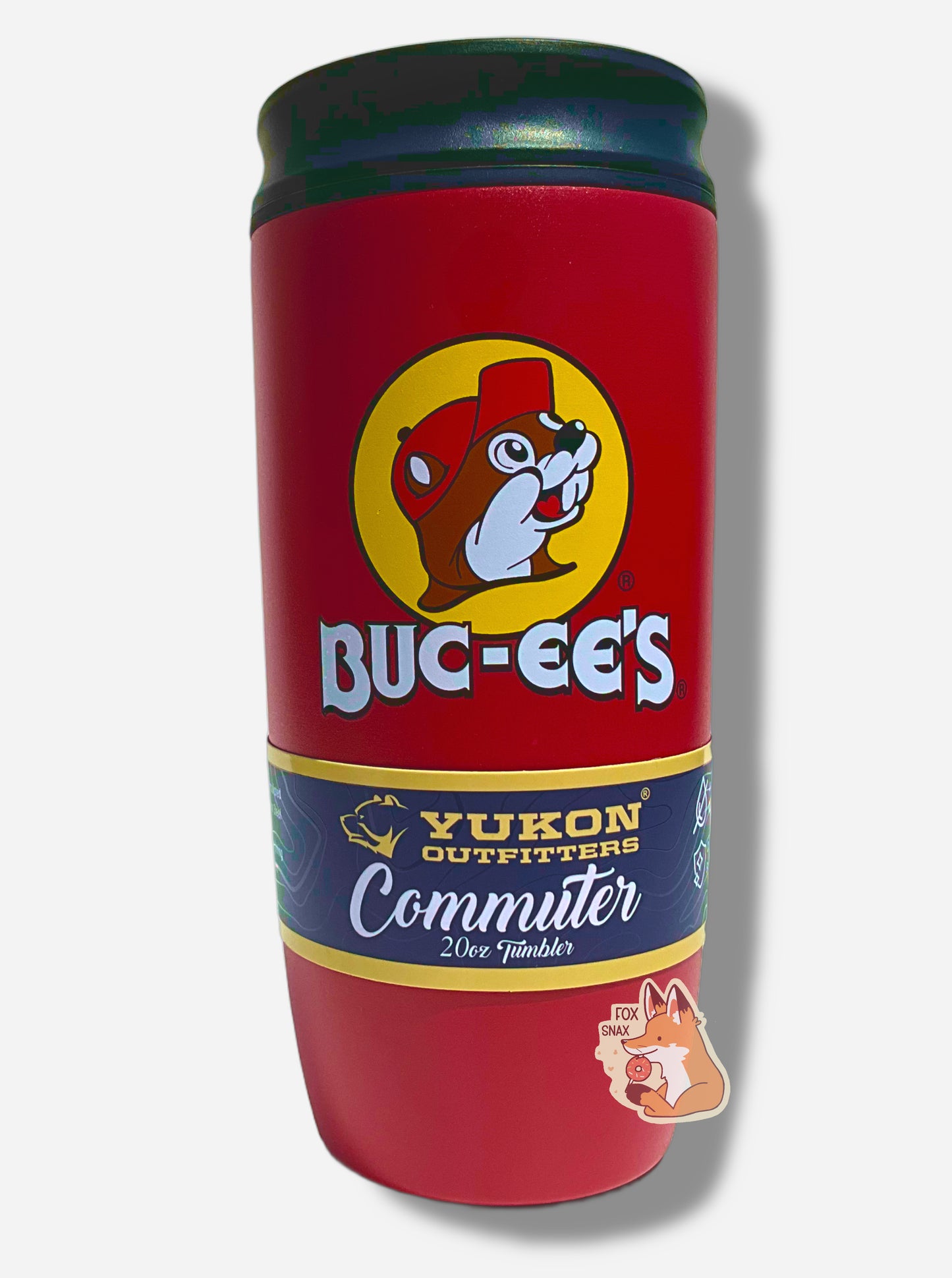 A picture of a medium sized 20oz tumbler, with a giant Buc-ee The Beaver logo on the side; he's framed by a yellow background, and is wearing a red ball cap.  The surface of the cup is red paint over metal.  The top of the cup features a black plastic lid.  The bottom surface is black plastic, and acts as a nice grippy surface so the cup doesn't slide around.