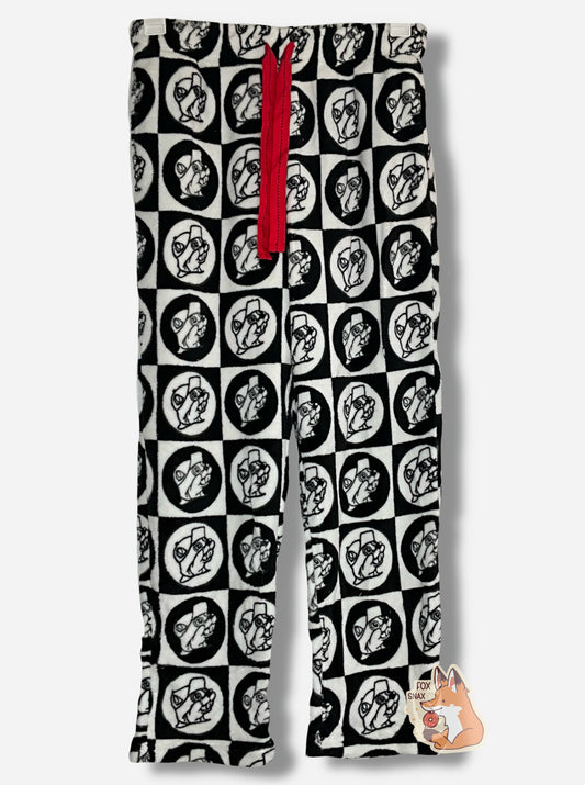 A picture of a pair of fuzzy lounge pants.  The pants are black and white; the surface has tons of Buc-ee beaver heads on it, checkered alternately in white and black circles and squares.  There is a red drawstring to cinch the pants around one's waist, and it is made of a red cloth.  