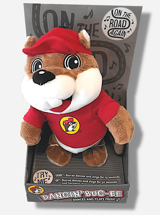 A picture of an adorable Buc-ee the Beaver plush.  The plush is of Dancin' Buc-ee, who is standing up on a grey product display.  He is wearing a red Buc-ee's shirt and red ball cap, and is looking at the viewer.  Buc-ee's is covered plush brown and white stuffed animal "fur".  Behind him the text reads "ON THE ROAD AGAIN", then "DANCIN' BUC-EE DANCES AND PLAYS MUSIC", then "DEMO- Buc-ee dances and sings for 15 seconds", "ON-Buc-ee dances and sings for 30 seconds"