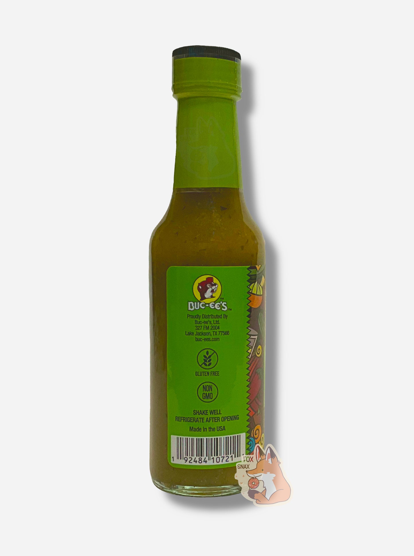 A picture of a small, tall glass bottle of hot sauce. The top of the bottle is sealed with a plastic top.  The back reads GLUTEN FREE, NON GMO, NO ARTIFICIAL COLORS OR FLAVORS, NO ARTIFICIAL PRESERVATIVES, then SHAKE WELL and REFRIGERATE AFTER OPENING.  Made in the USA.  The sauce inside is green/yellow with darker green flecks.