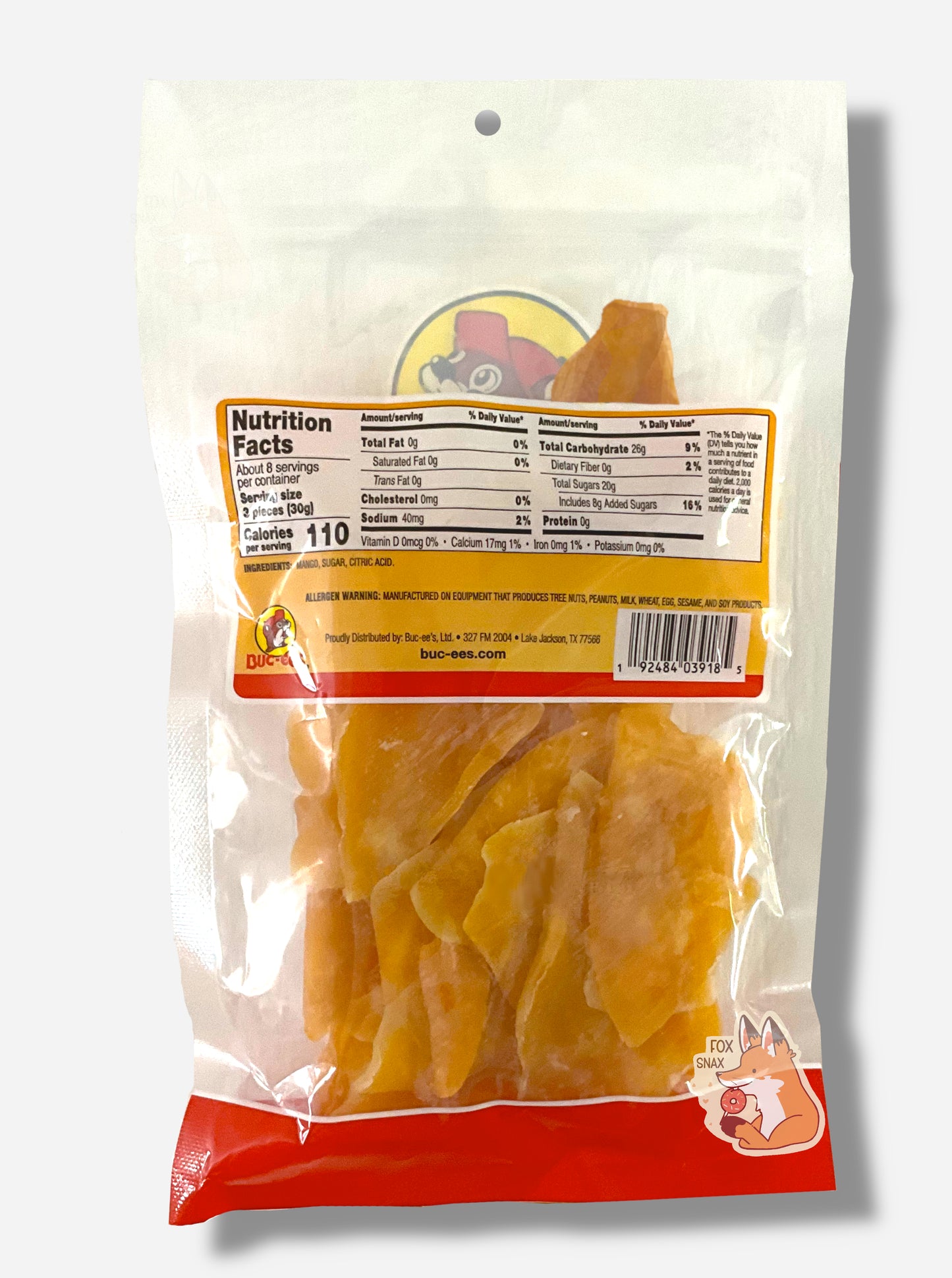 A picture of the back of a resealable bag of Buc-ee's Sweetened Dried Mango Slices, which are large orange-yellow dried slices of mango.  The bag lists nutrition facts, then ingredients.