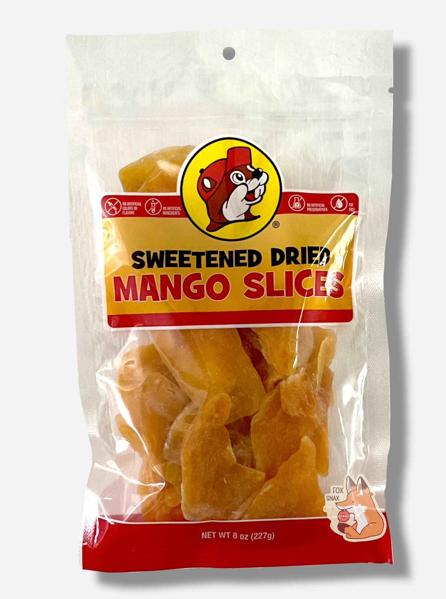 A picture of the front of a resealable bag of Buc-ee's Sweetened Dried Mango Slices, which are large orange-yellow dried slices of mango.  The bag reads Sweetened Dried Mango Slices, then No Artificial Colors and Flavors, then No Artificial Ingredients, then No Artifiicial Preservatives, then Fat Free.  The bag  has a picture of Buc-ee the Beaver on it - a large, brown-furred beaver with a large overbite, wearing a red ball cap. 