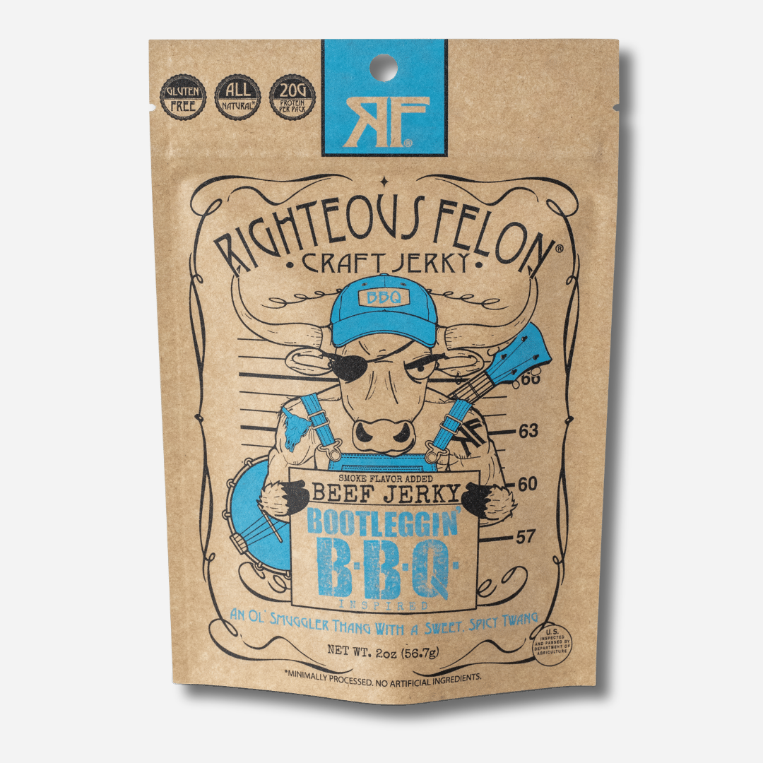 A picture of the front of a kraft paper bag of Righteous Felon Bootleggin' BBQ Beef Jerky with a light blue RF logo and Gluten Free, All Natural, and 20g Protein per Pack badges.  A cartoon bull in a blue BBQ cap, eye patch, and overalls, with a banjo on his back, poses for a mugshot holding a sign that reads "Beef Jerky, Bootleggin' B-B-Q".  At the bottom: "An Ol' Smuggler Thang With a Sweet, Spicy Twang", Net Wt. 2oz.