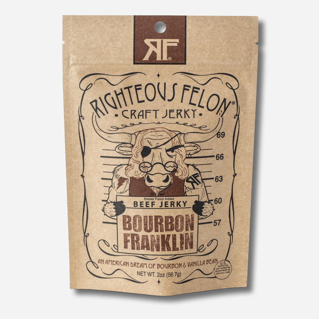 A picture of the front of a kraft paper bag of Righteous Felon Bourbon Franklin Beef Jerky with a brown RF logo at the top.  Below the Righteous Felon Craft Jerky text, a cartoon bull with long Ben Franklin hair, round spectacles, and an eye patch poses for a mugshot in front of a height chart, holding a sign that reads "Beef Jerky, Bourbon Franklin".  At the bottom it reads "An American Dream of Bourbon & Vanilla Bean" and "Net Wt. 2oz (56.7g)".