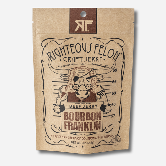 A picture of the front of a kraft paper bag of Righteous Felon Bourbon Franklin Beef Jerky with a brown RF logo at the top.  Below the Righteous Felon Craft Jerky text, a cartoon bull with long Ben Franklin hair, round spectacles, and an eye patch poses for a mugshot in front of a height chart, holding a sign that reads "Beef Jerky, Bourbon Franklin".  At the bottom it reads "An American Dream of Bourbon & Vanilla Bean" and "Net Wt. 2oz (56.7g)".