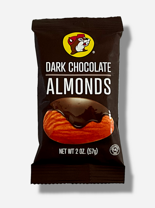 A picture of the front of a small package of Buc-ee's Dark Chocolate Almonds, 2 oz.  The bag has a small picture of Buc-ee the Beaver on the top, and the bottom has a picture of a single giant almond, covered in dark chocolate.  The bag is dark brown.