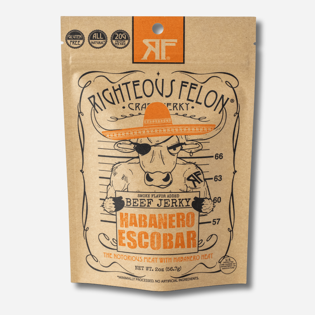 A picture of the front of a kraft paper bag of Righteous Felon Habanero Escobar Beef Jerky with an orange RF logo at the top.  Badges in the corner read "Gluten Free", "All Natural", and "20g Protein per Pack".  Below the Righteous Felon Craft Jerky text, a cartoon bull in an orange sombrero and eye patch poses for a mugshot in front of a height chart, holding a sign that reads "Beef Jerky, Habanero Escobar".  At the bottom it reads "The Notorious Meat With Habanero Heat" and "Net Wt. 2oz (56.7g)".