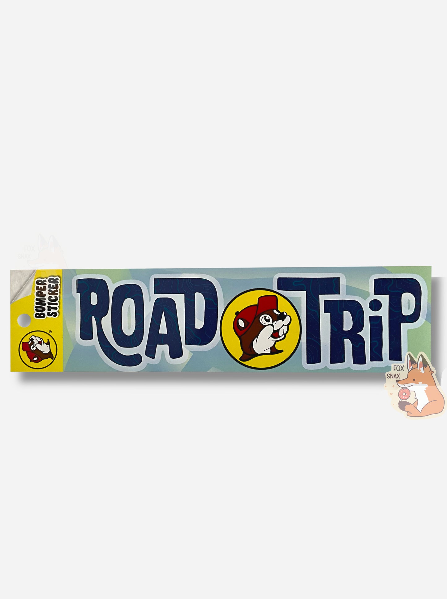 A picture of a blue/green bumper sticker that says ROADTRIP.  In between the words ROAD and TRIP is the circular Buc-ee's logo.  The background is a series of light blue and green wavy shapes and the letters are dark blue, surrounded in white.  The font is a print font, not a cursive one, but is sorta wavy and capitalized oddly.