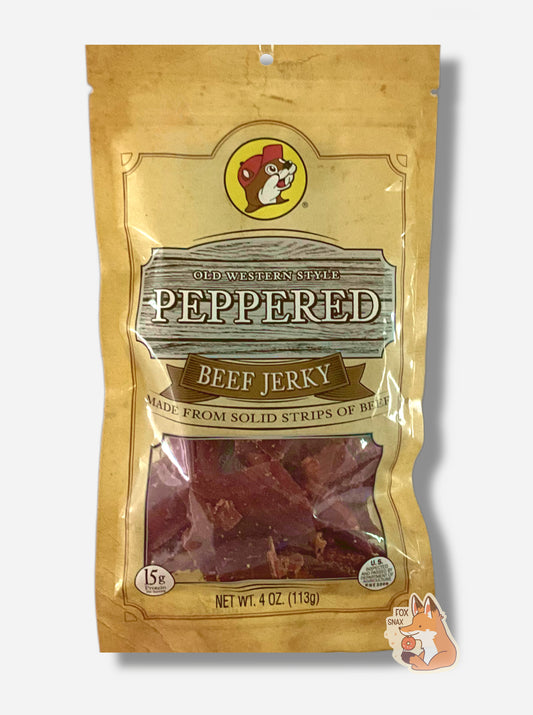 A picture of the front of a tan plastic bag of Buc-ee's Old Western Style Peppered Jerky.  The logo is in brown with white text.The label underneath reads 'Made From Solid Strips Of Beef'. A small window on the bottom of the bag shows the red dried jerky inside.  The bag has a picture of Buc-ee the Beaver on it.