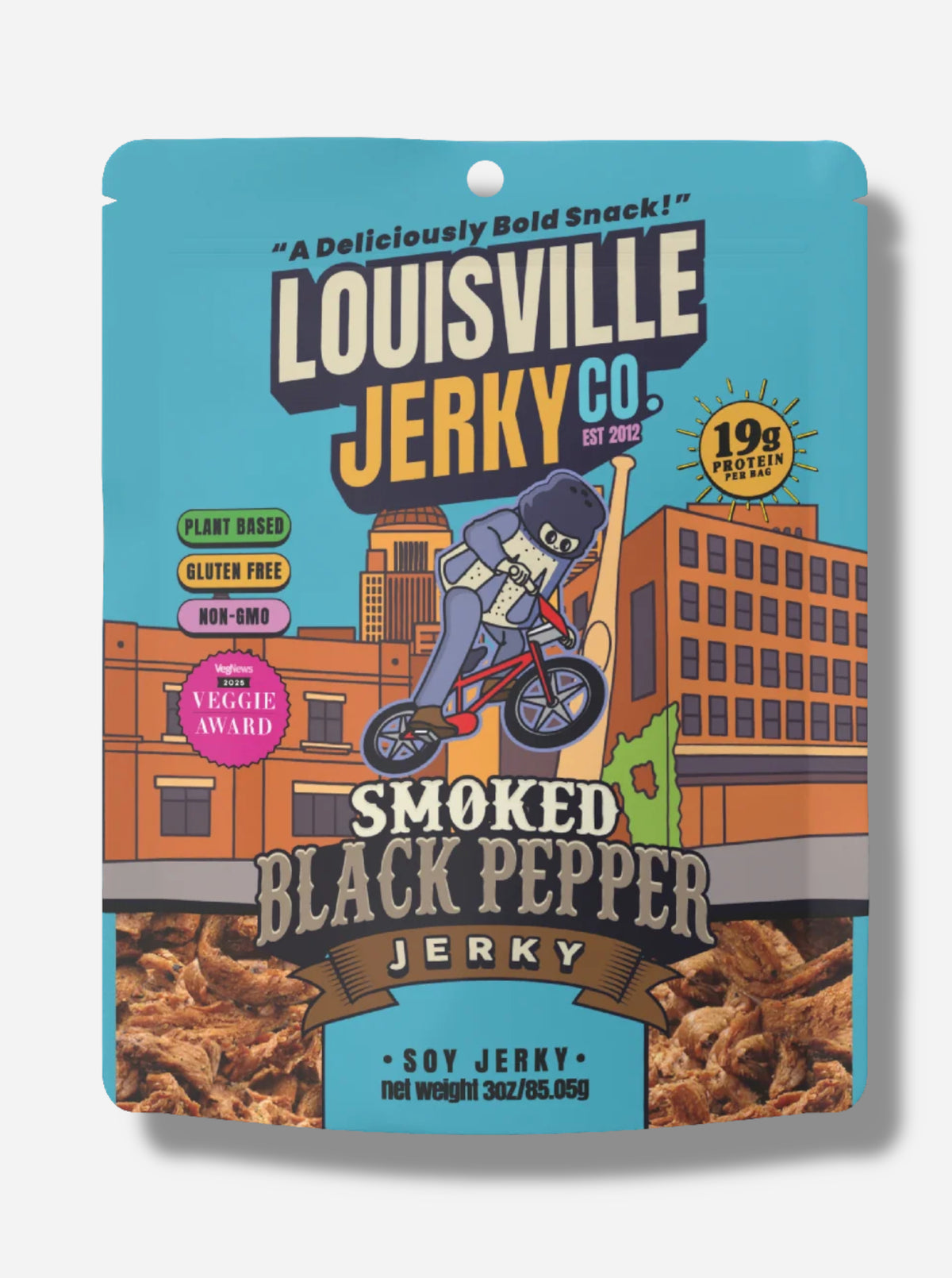 A picture of the front of an orange bag of Louisville Jerky Co. Smoked Black Pepper Jerky. Above the Louisville text reads "A Deliciously Bold Snack!", and next to it, reads "19g Protein per bag", "Plant Based", "Gluten Free", "Non-GMO", and "VegNews 2025 Veggie Award", then "Smoked Black Pepper Jerky, Soy Jerky". There is a depiction of the Louisville skyline; in the foreground is a cartoon of a person wearing black pepper shaker costume, riding a sweet red bicycle!