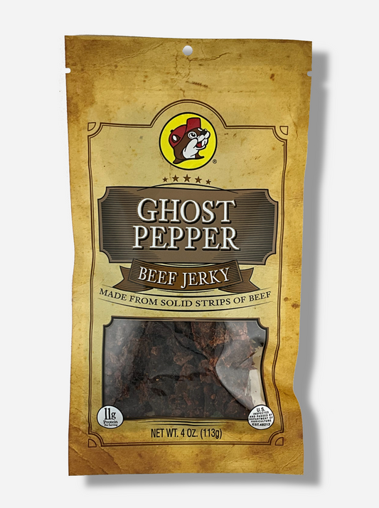 A picture of the front of a tan plastic bag of Buc-ee's Ghost Pepper Beef Jerky.  The logo is in tan with white text.  The label underneath reads 'Made From Solid Strips Of Beef'.A small window on the bottom of the bag shows the dark brown/red dried jerky inside.  The bag has a picture of Buc-ee the Beaver on it.