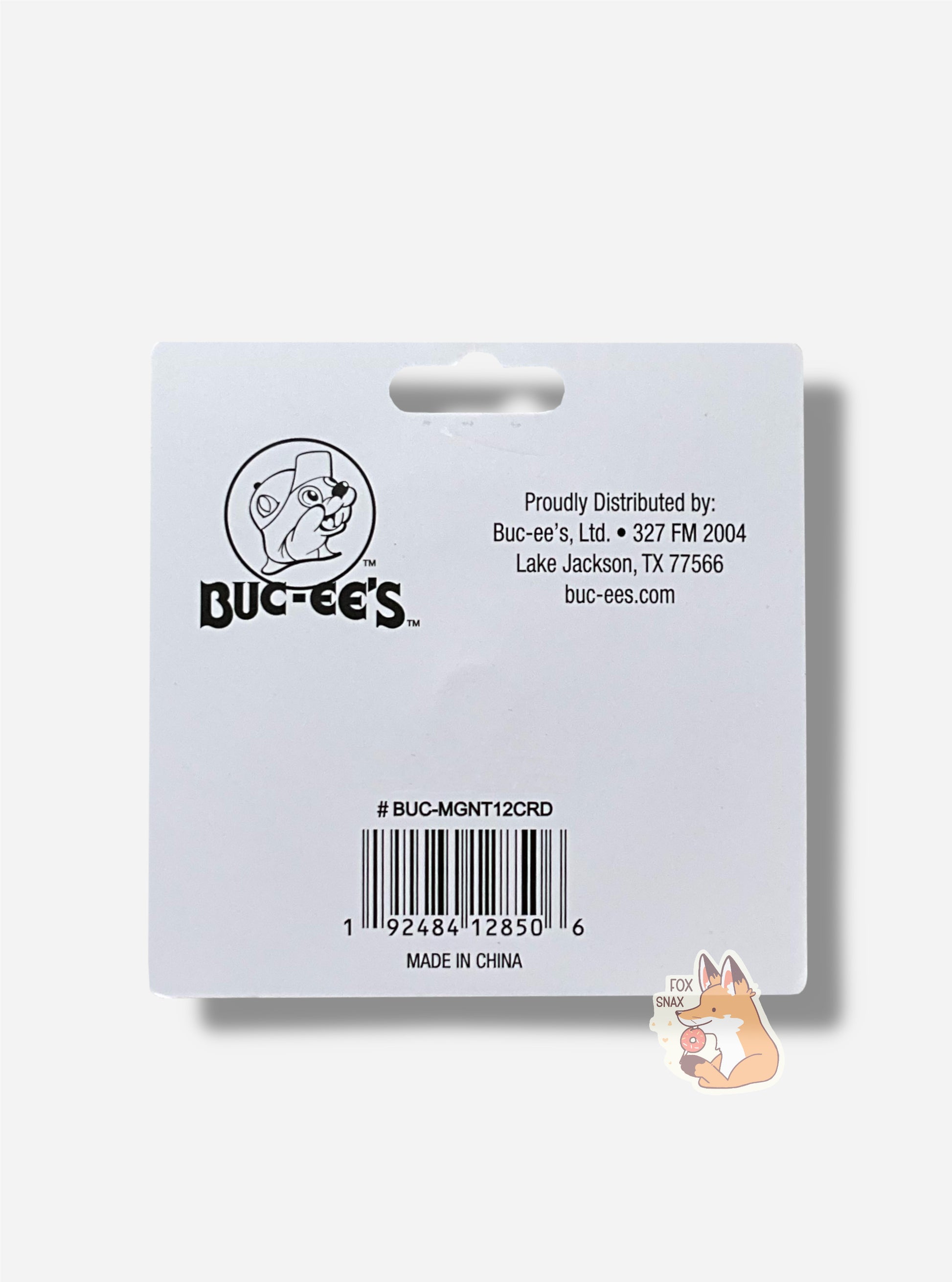 A picture of a square cardboard backing for the Collectible Magnet.  It features the Buc-ee's logo in black and white.